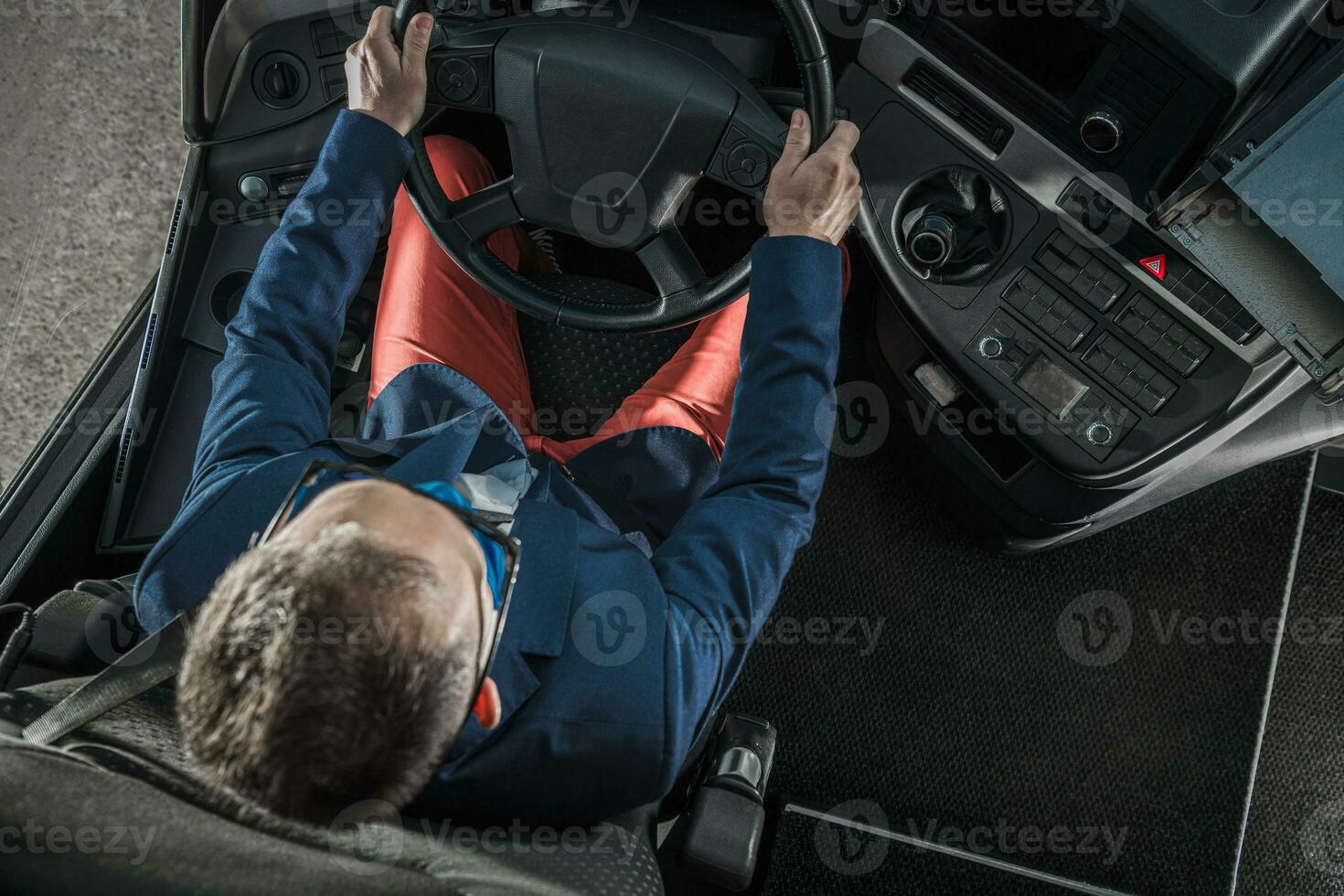 Shuttle Bus Caucasian Driver and Vehicle Cockpit Top View photo