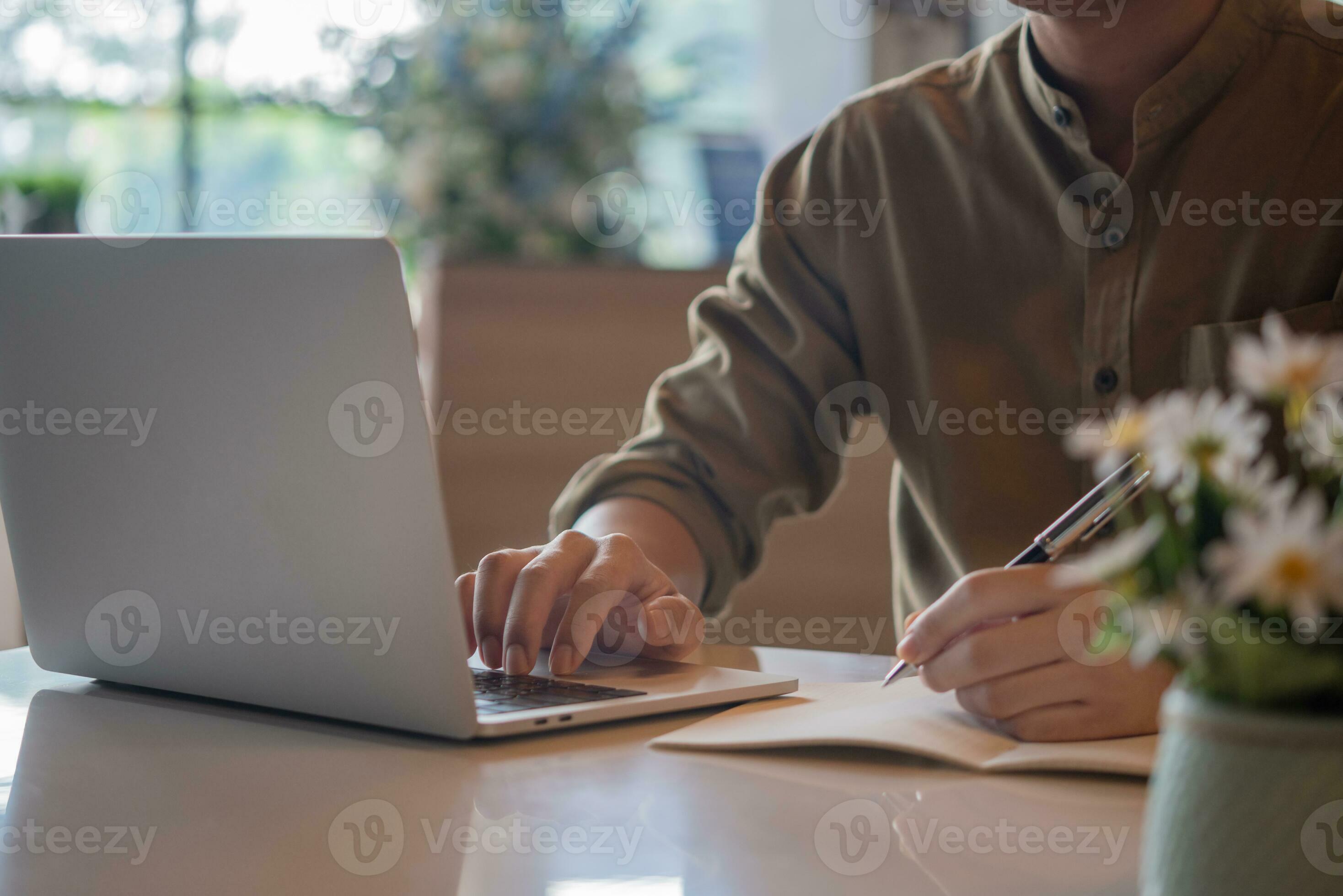hand man writing notes workspace using a computer. communication and ...