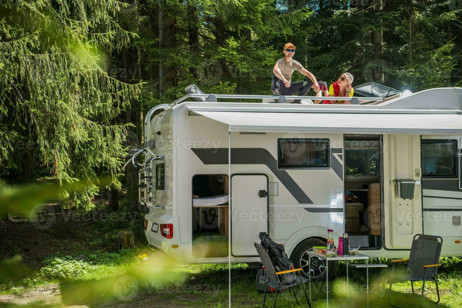 Happy Family Relaxing on the Roof of Their RV photo