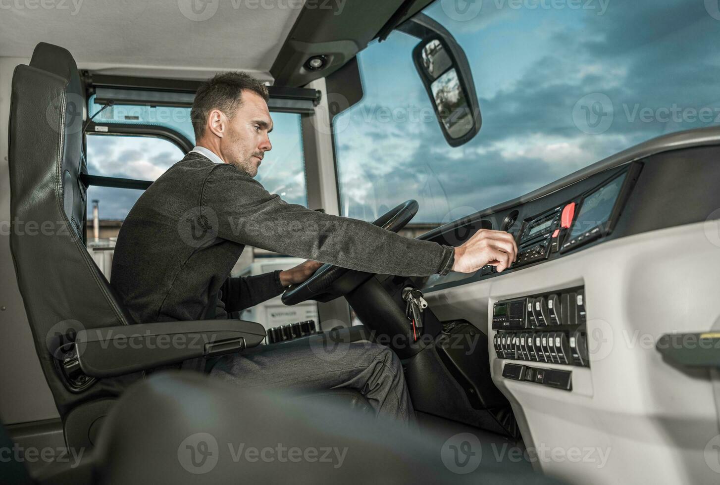 International Motor Coach Bus Driver Preparing For Another Trip photo