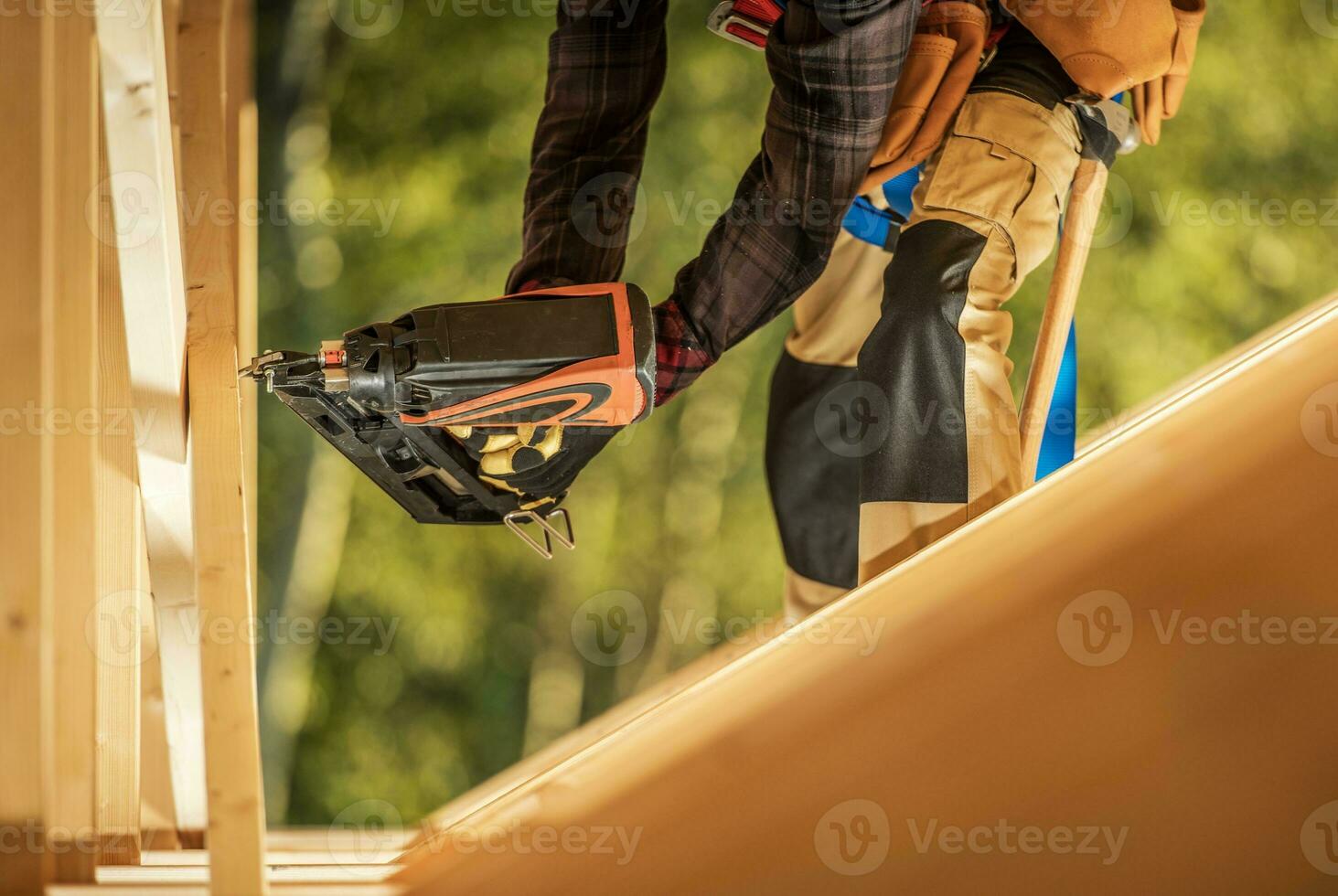 Worker with Nail Gun photo
