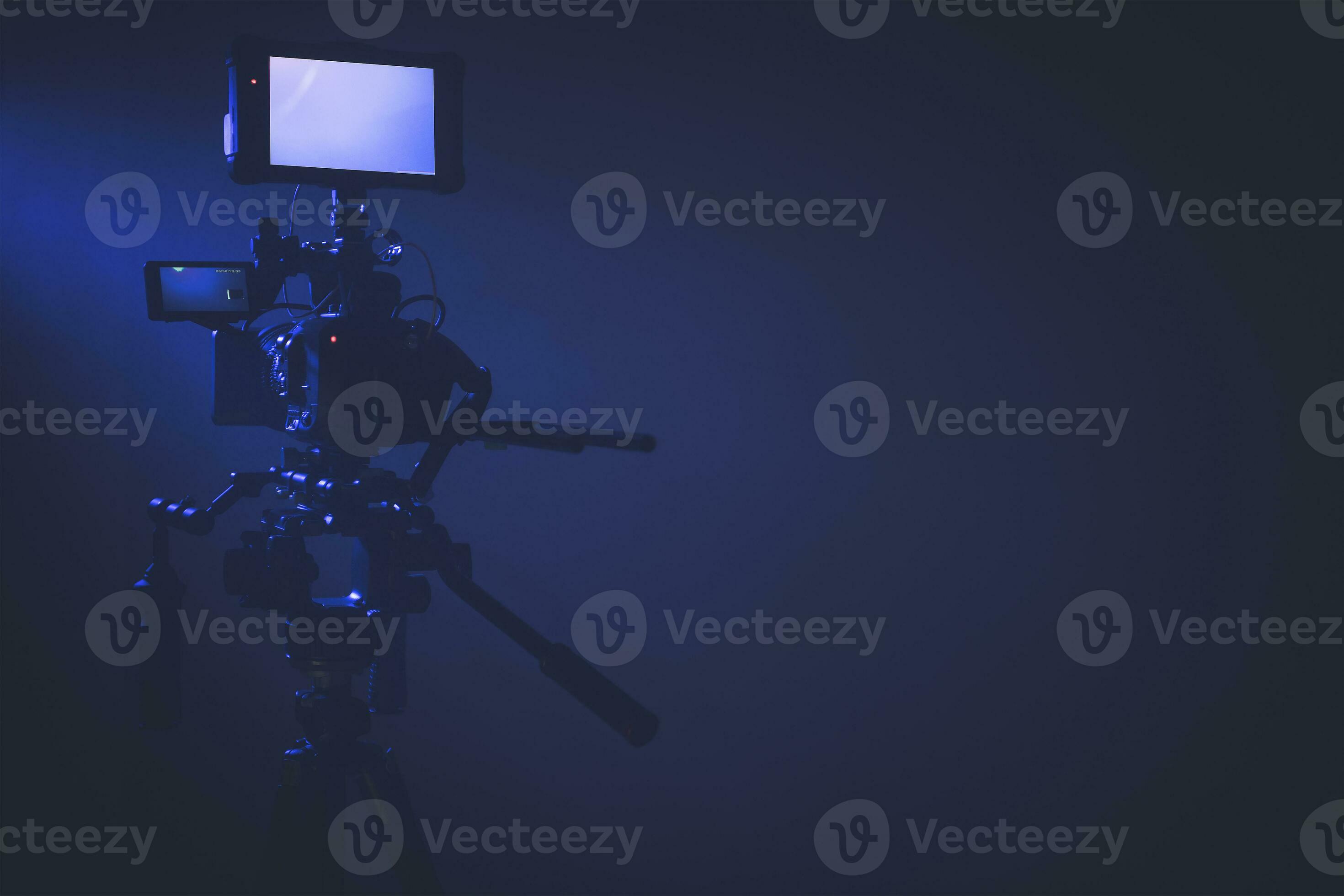 Modern Digital Cinema Camera with External Display Staying on a Tripod