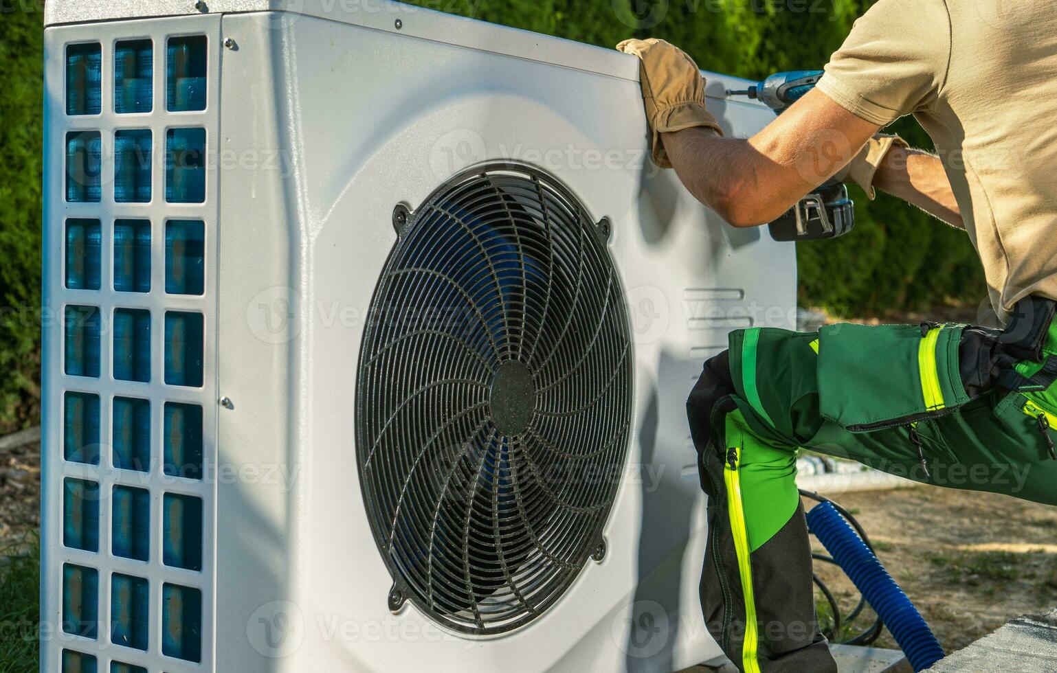 HVAC Worker Installing Electric Heat Pump photo