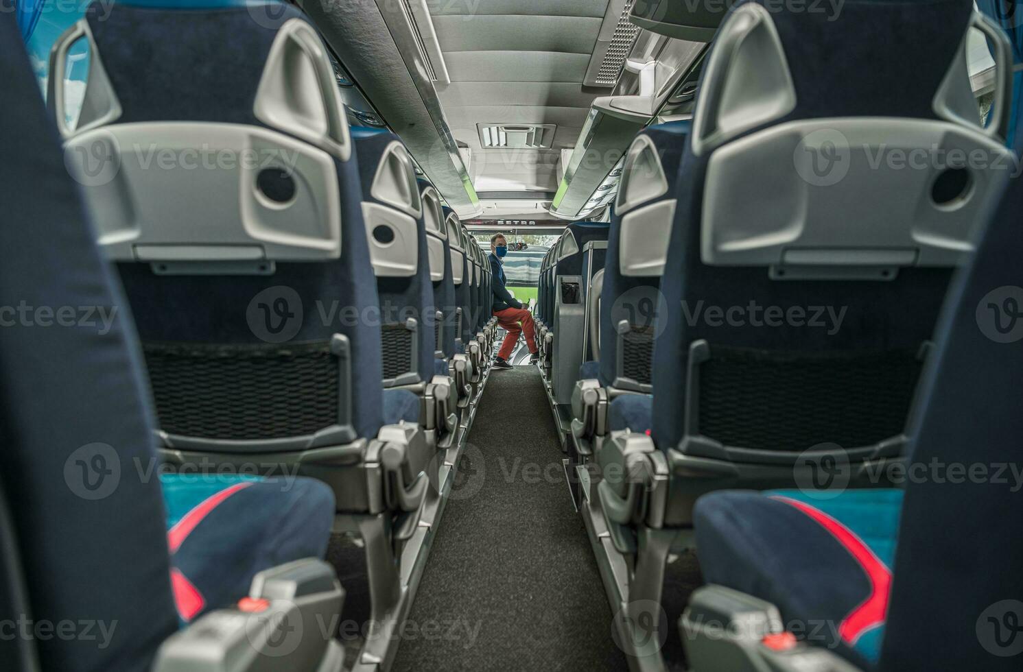 Shuttle Bus Driver Awaiting Passengers Inside the Vehicle During Virus Outbreak photo