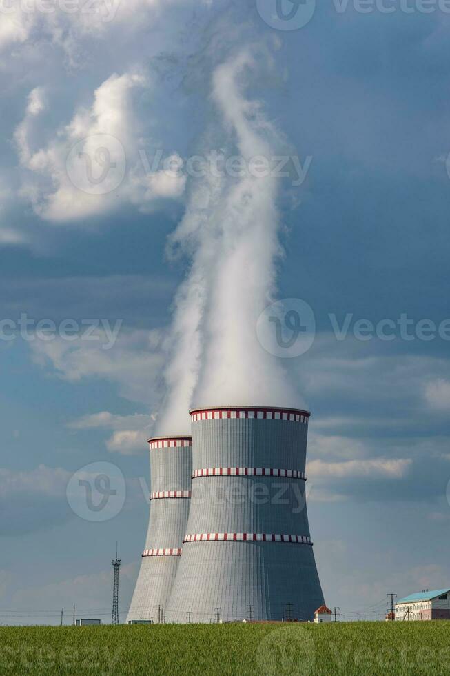Cooling towers of nuclear power plant against the blue sky photo