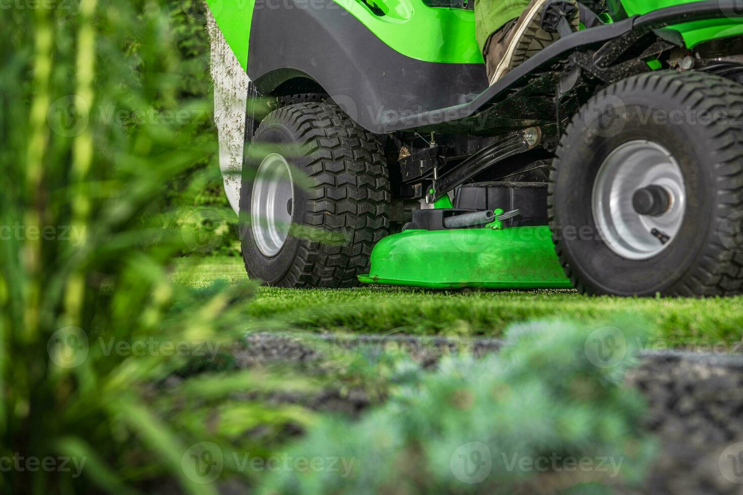 Backyard Grass Mowing Using Riding Garden Tractor photo