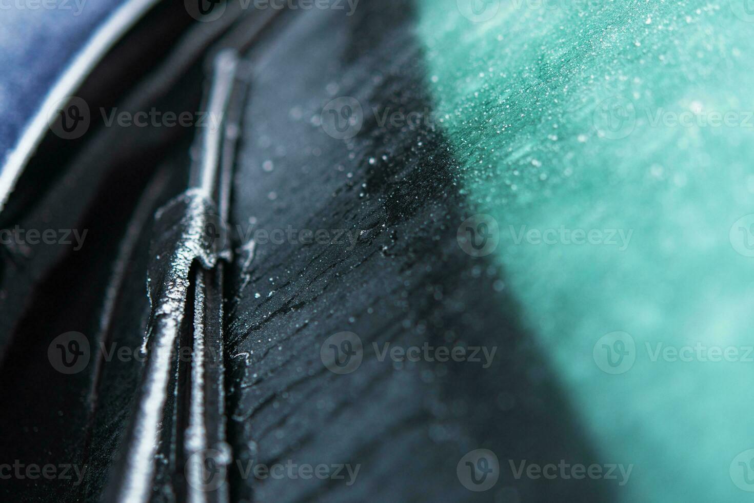 Car Windshield and Wiper Covered by Frost and Ice photo