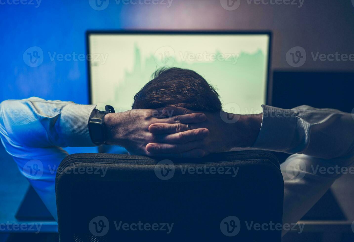Satisfied Trader Looking at Stock Market Graphs photo
