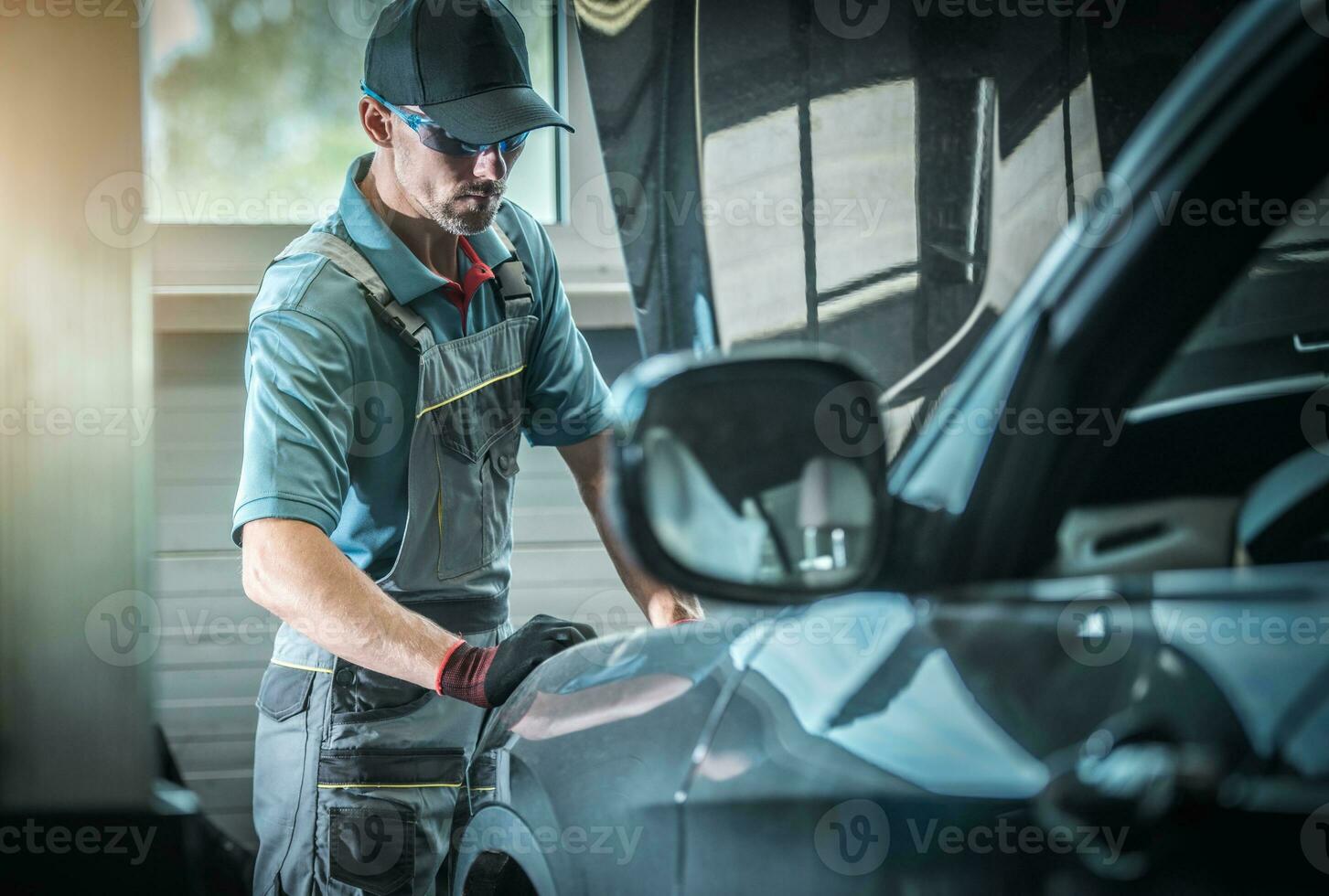 Car Mechanic Fixing Vehicle photo