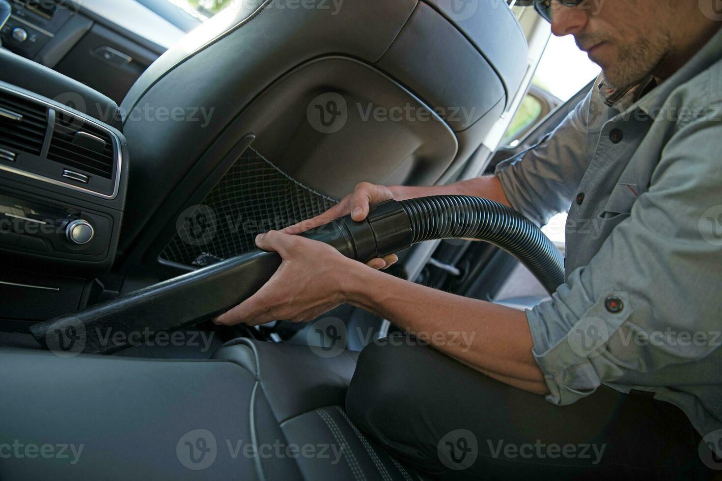 Men Vacuuming His Car photo