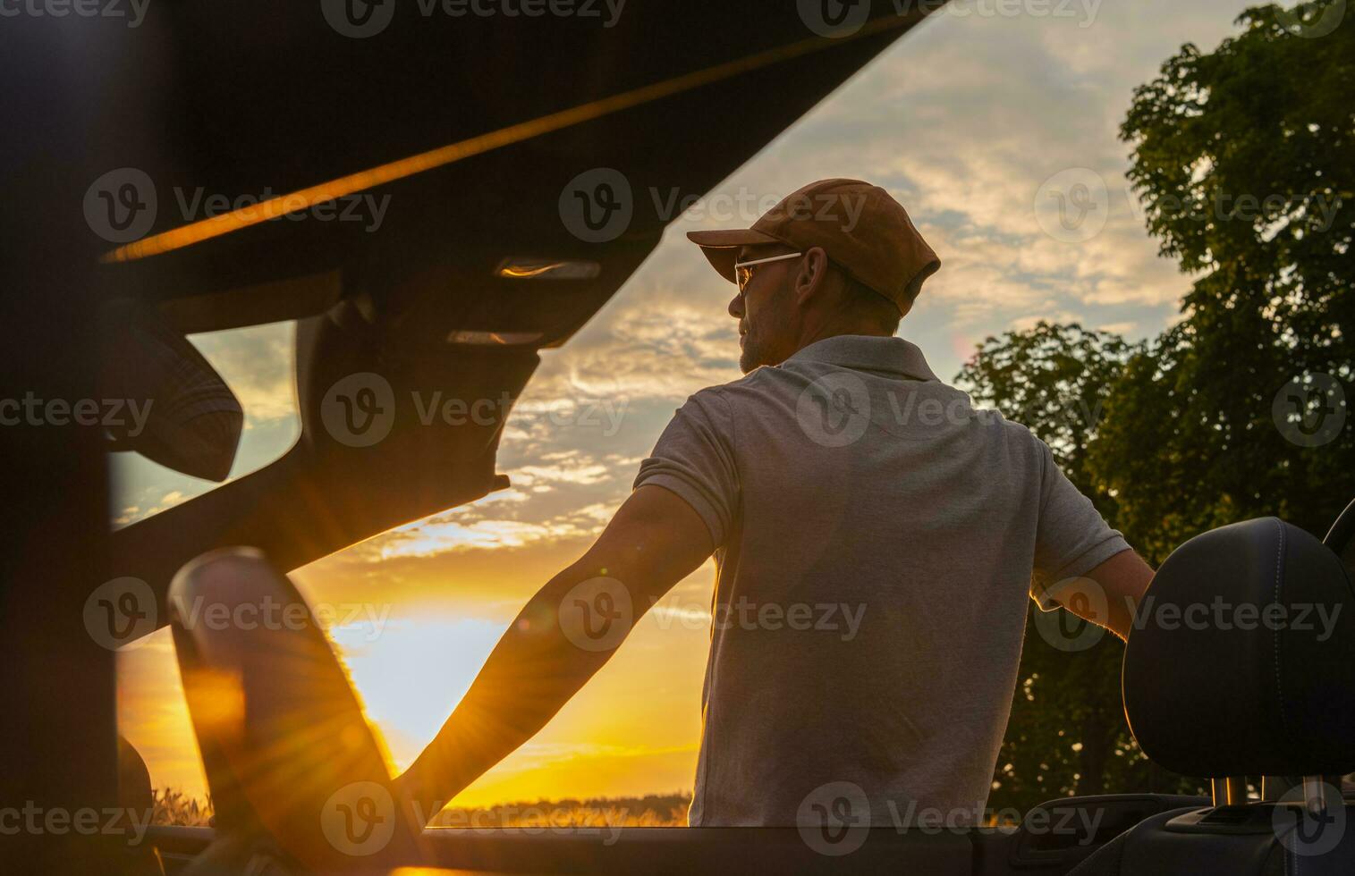 Men Stop on Side of the Road to Enjoy Scenic Sunset photo