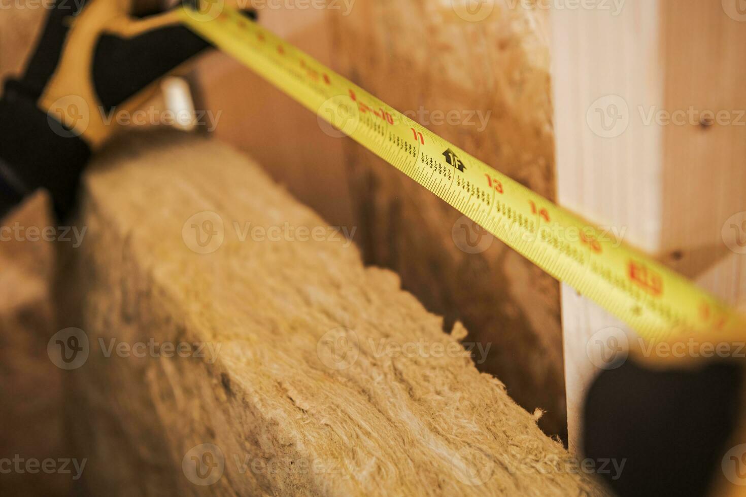 Carpenter Measuring Area With Tape Measure. photo