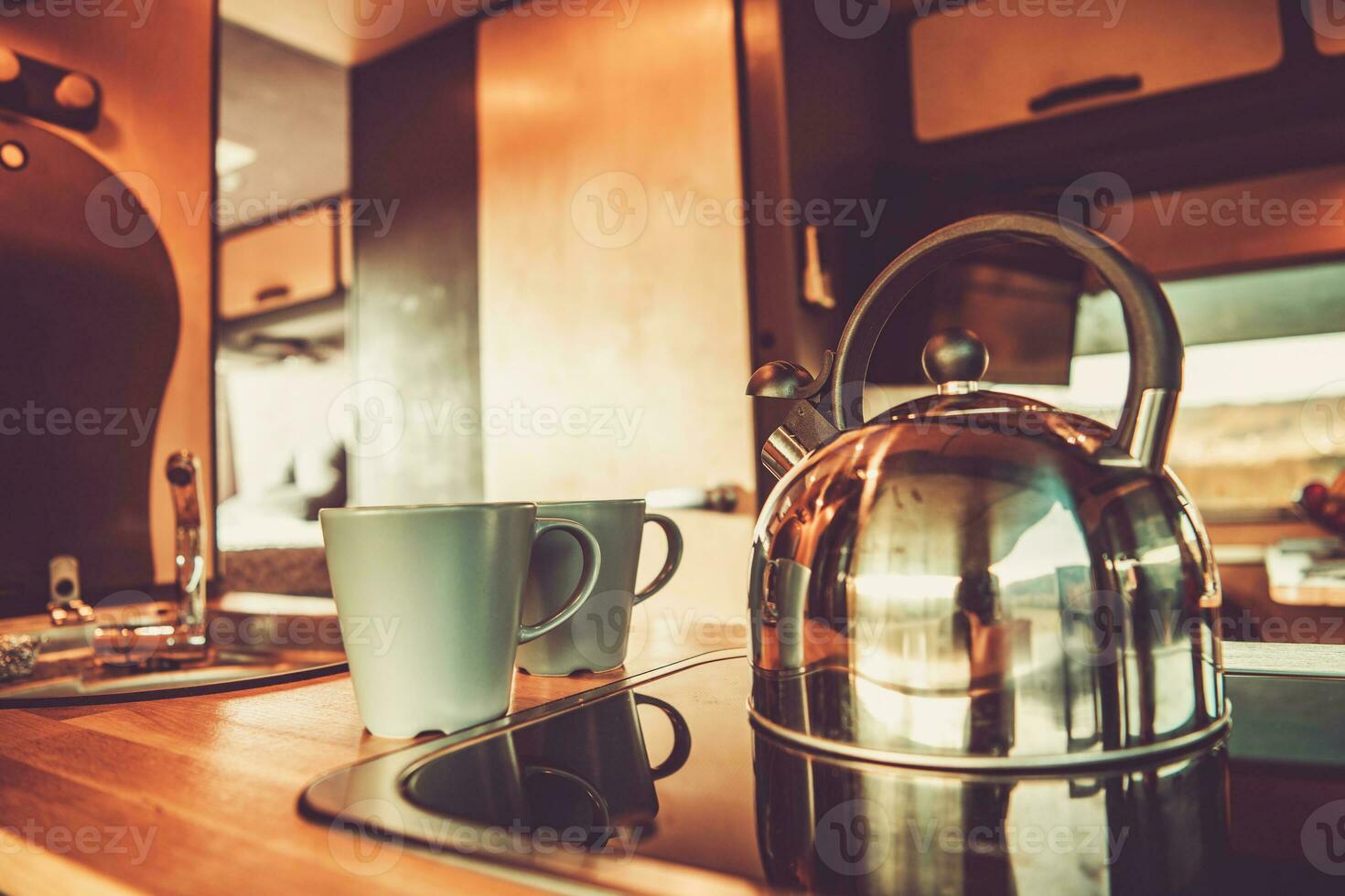 Kettle and Two Cups with Hot Tea Inside RV Camper Van photo