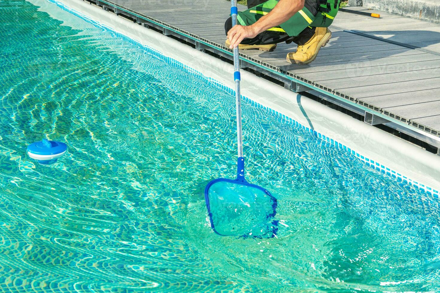 Cleaning Swimming Pool with Skimmer Net photo