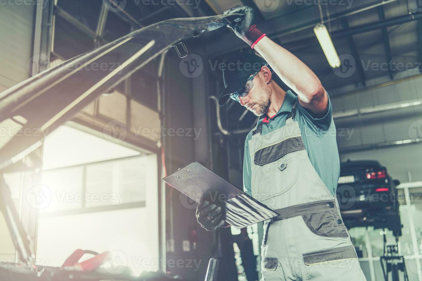 Caucasian Car Mechanic Electronic Elements Technician Checking on an Issue photo