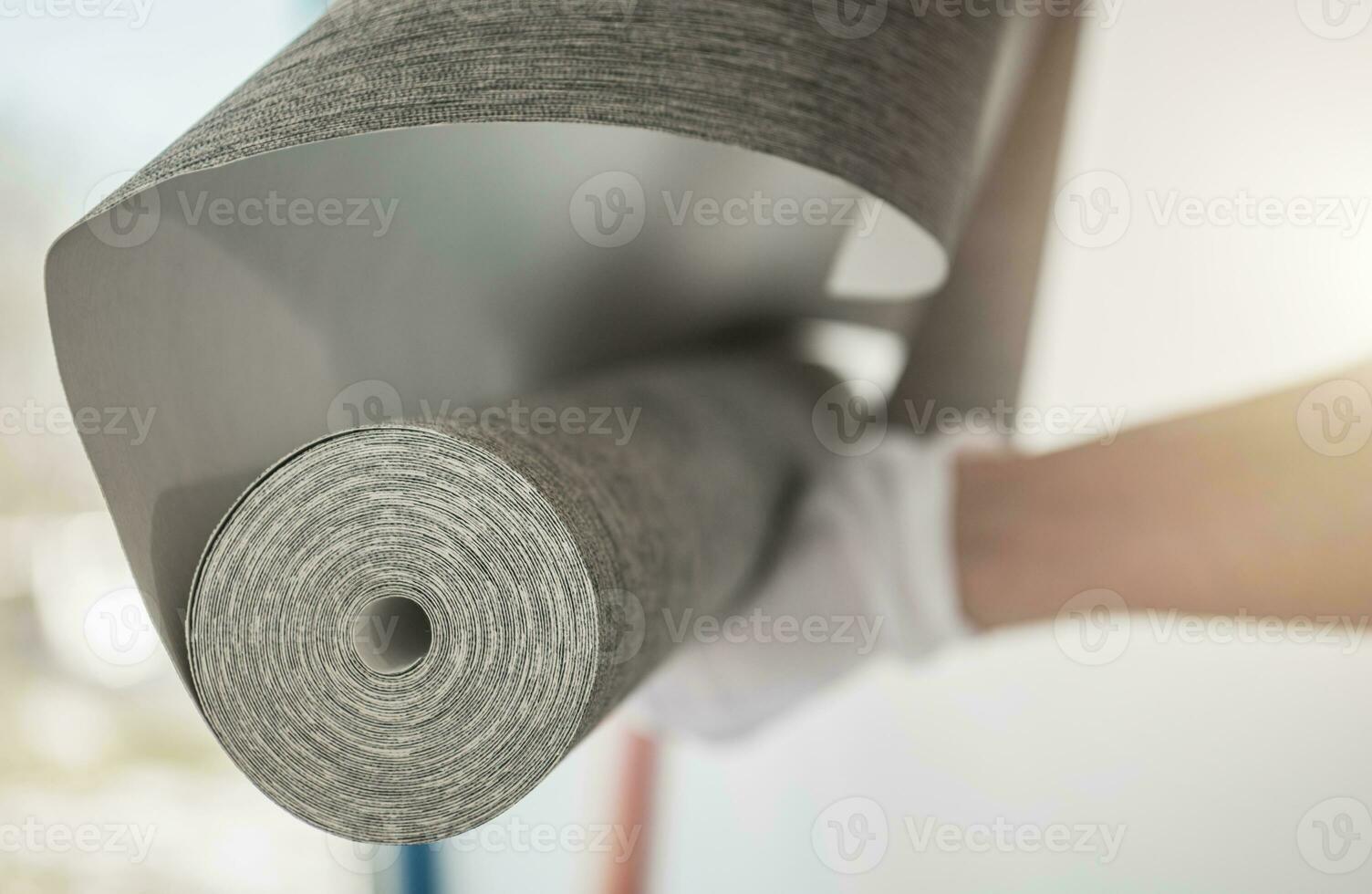 Interior Remodeling Worker with Roll of Modern Vinyl Wallpaper photo