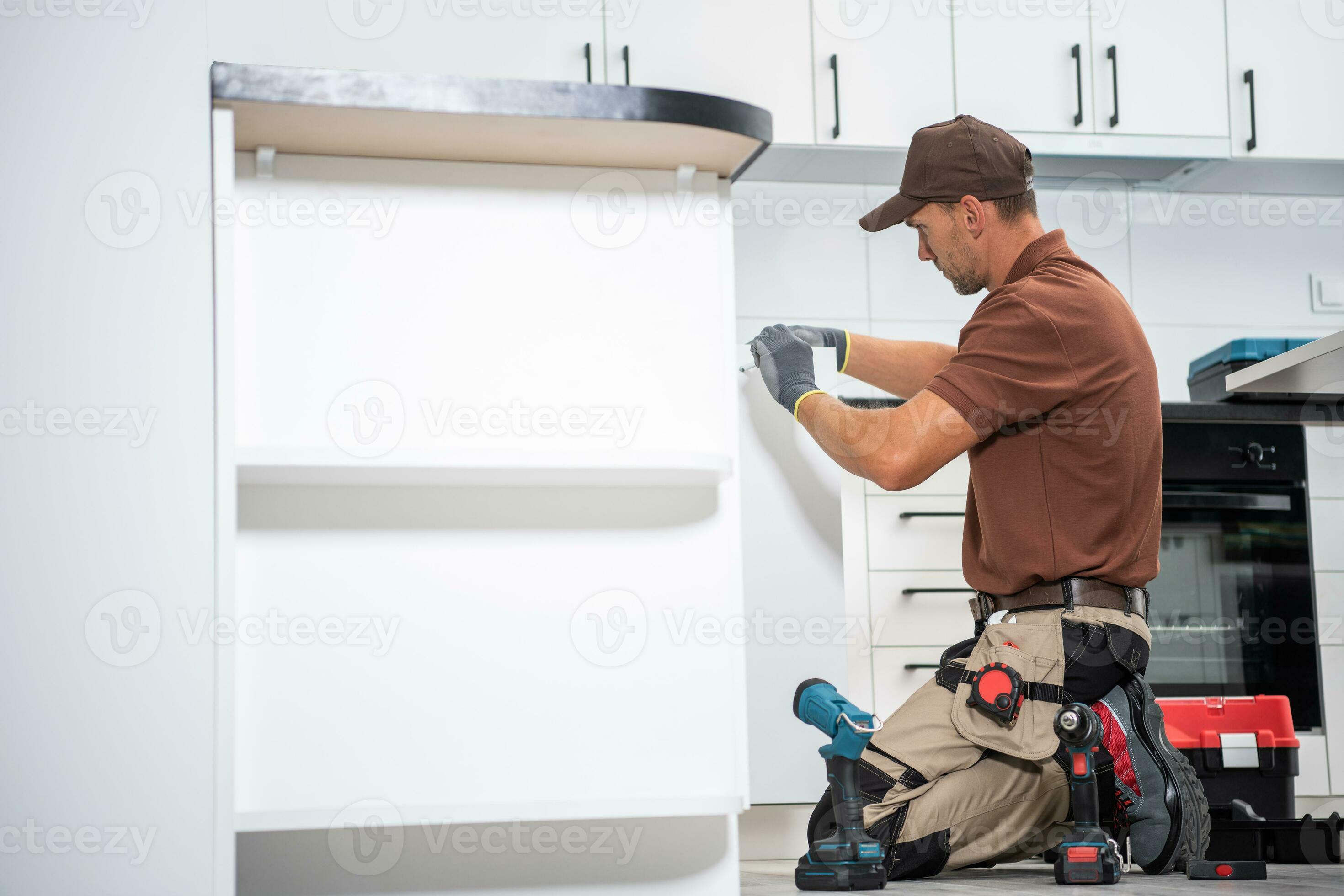 Contractor Worker Finishing Installation of a New Kitchen
