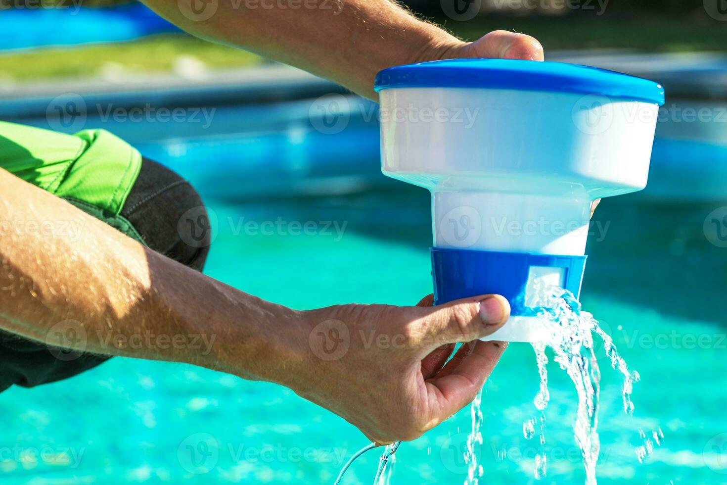 Pool Chemical Dispenser in Hands of Technician photo