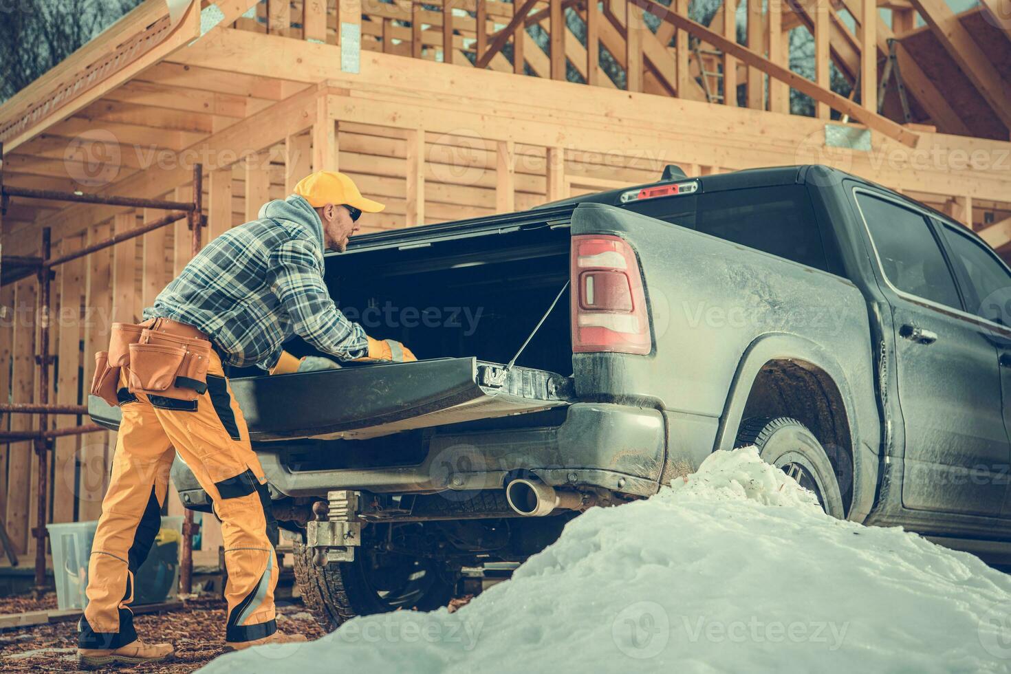 Constructor Preparing the Cargo Bed of His Pickup Truck for the Load photo