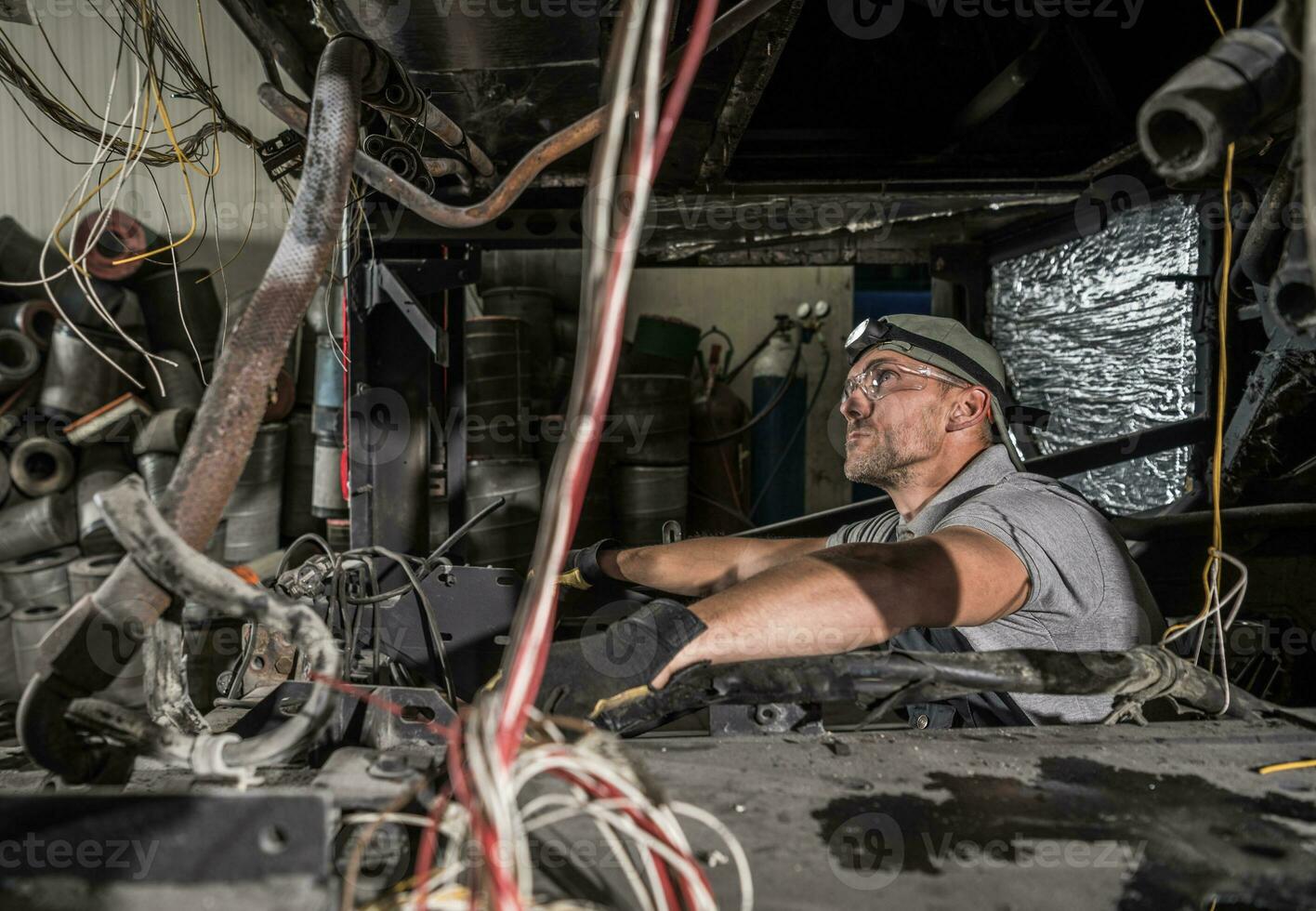Mechanic Inside RV Coach Bus Diesel Engine Compartment photo