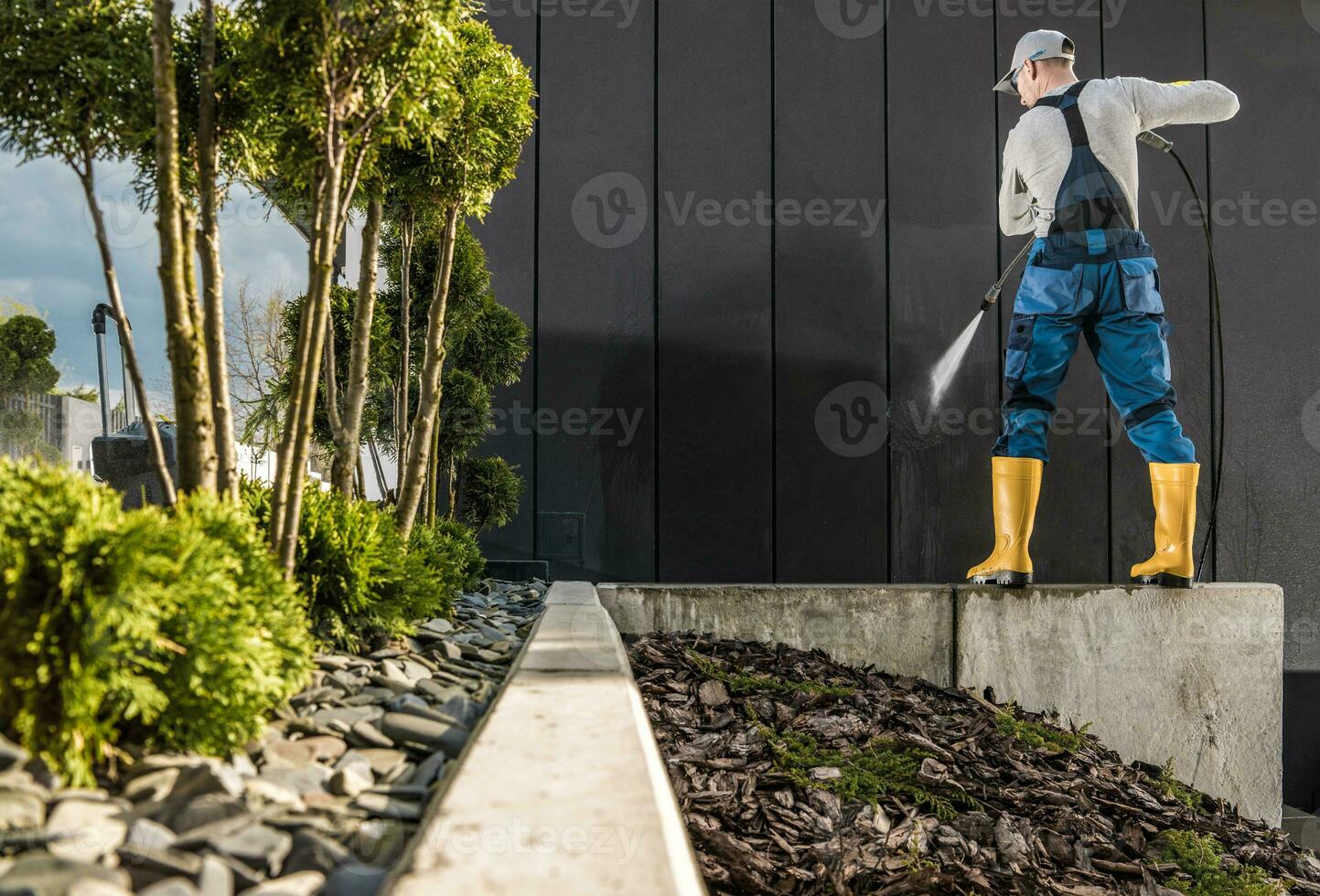 Professional Worker Pressure Washing House Walls photo