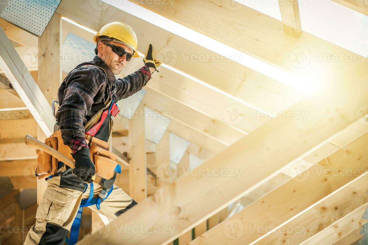 Contractor Working on Wooden House Frame photo