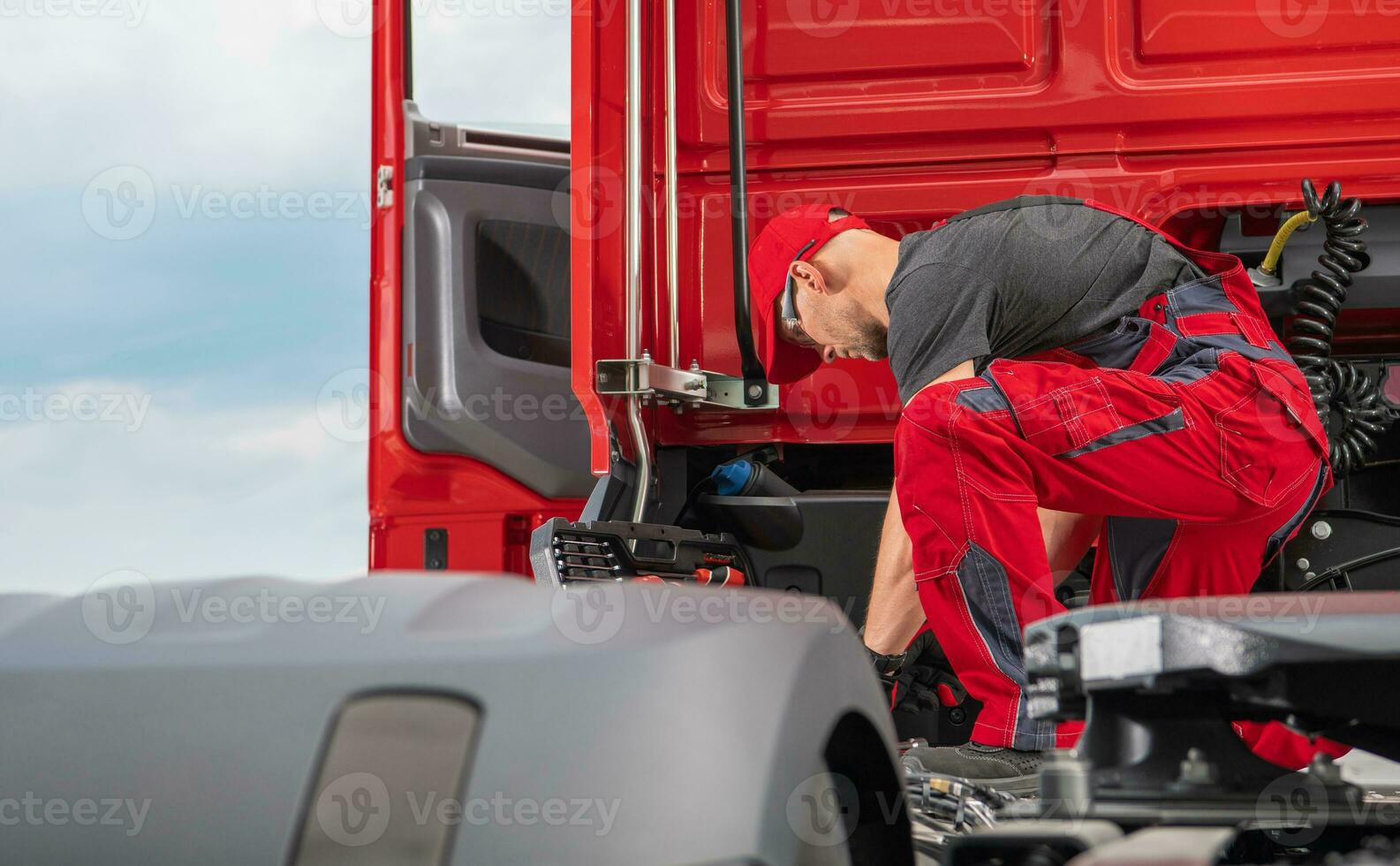 Professional Truck Mechanic Performing Semi Truck Repair photo