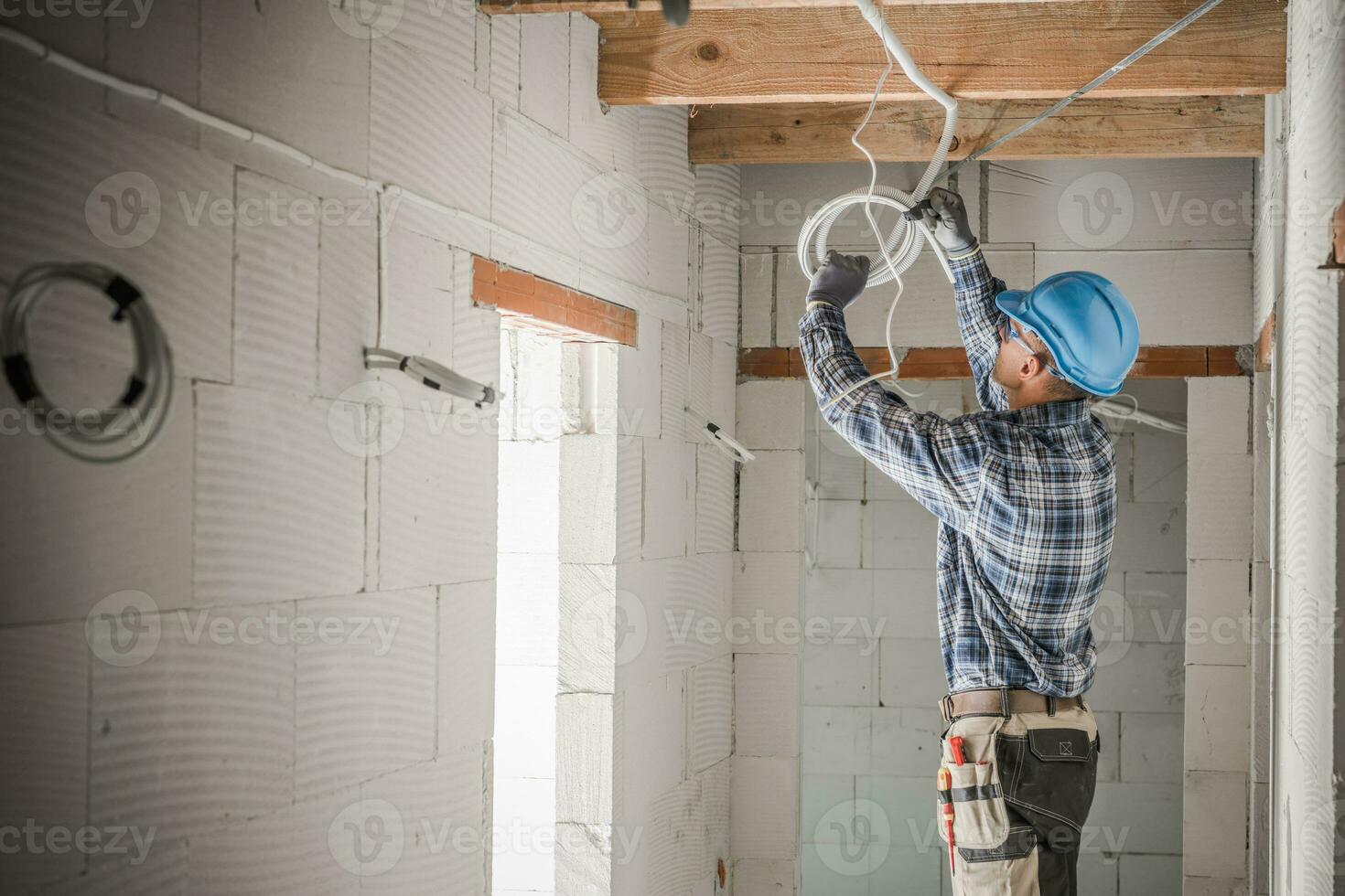 Worker Installing Electrical Cables Line photo