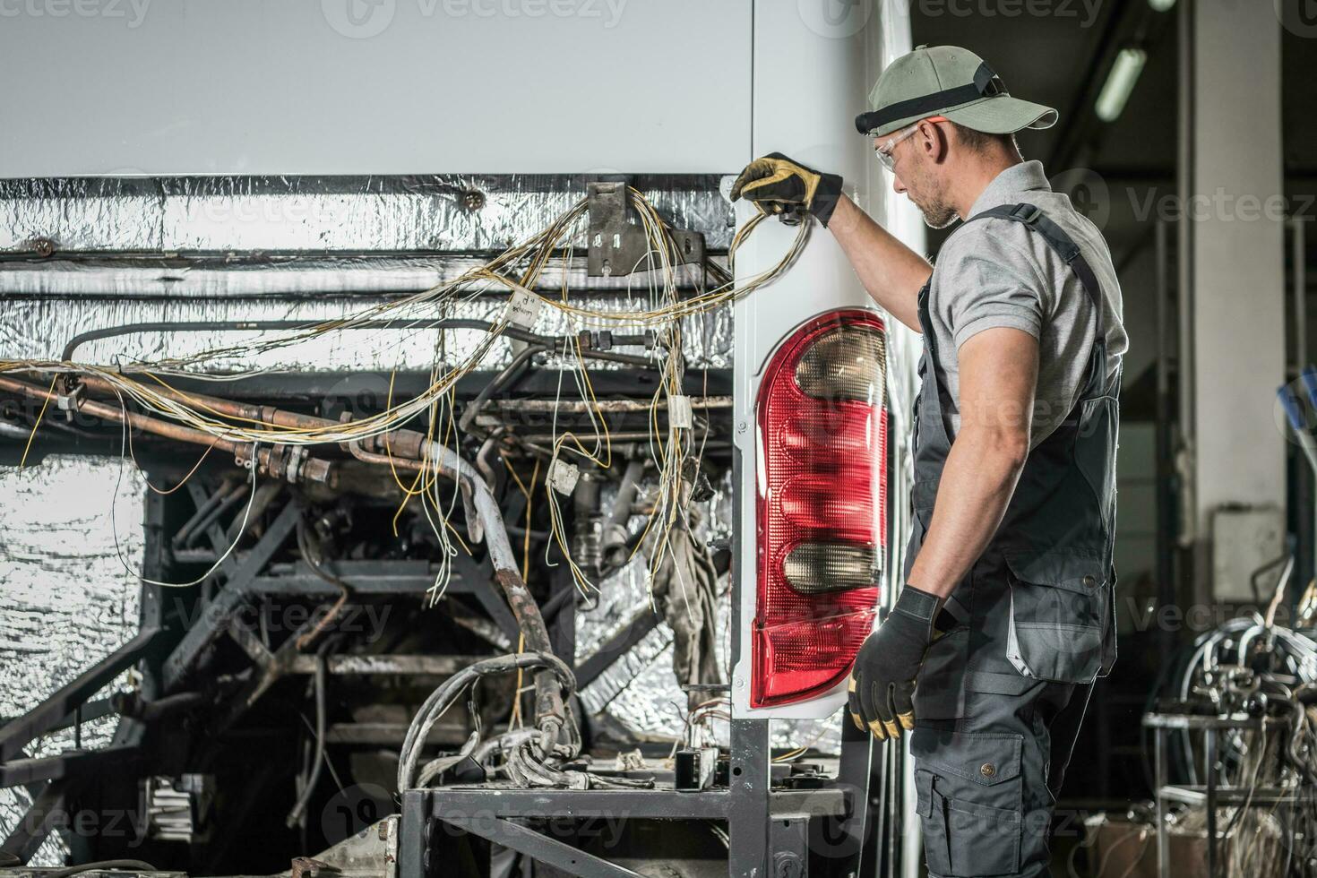 Bus Service Technician Staying in Front of Vehicle With No Diesel Engine Inside photo