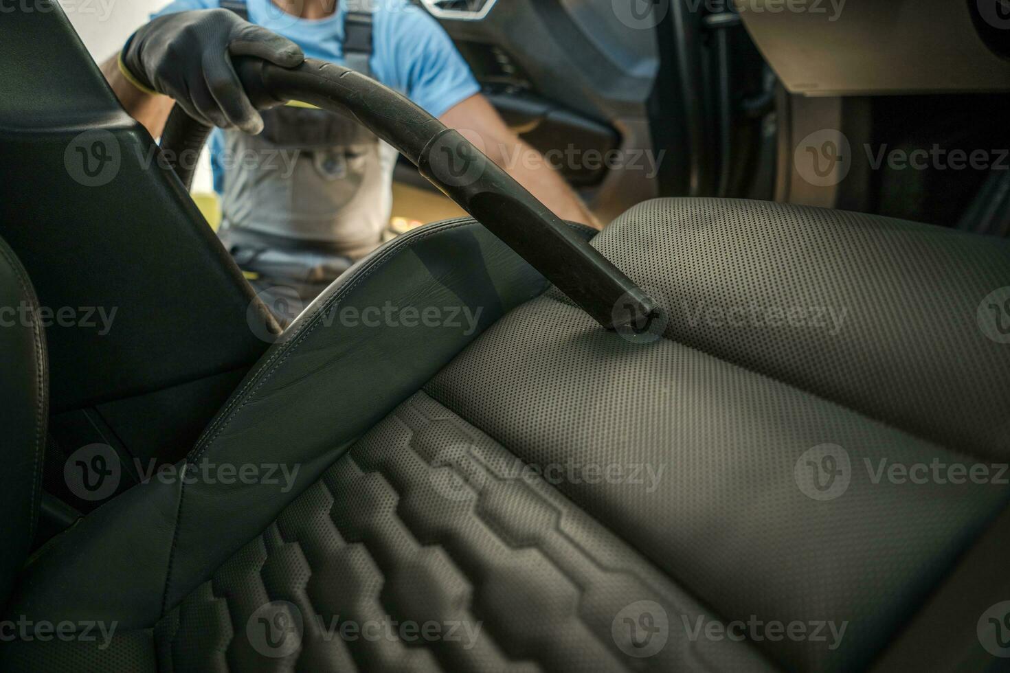 Men Vacuuming His Modern Car Seats and Interior photo