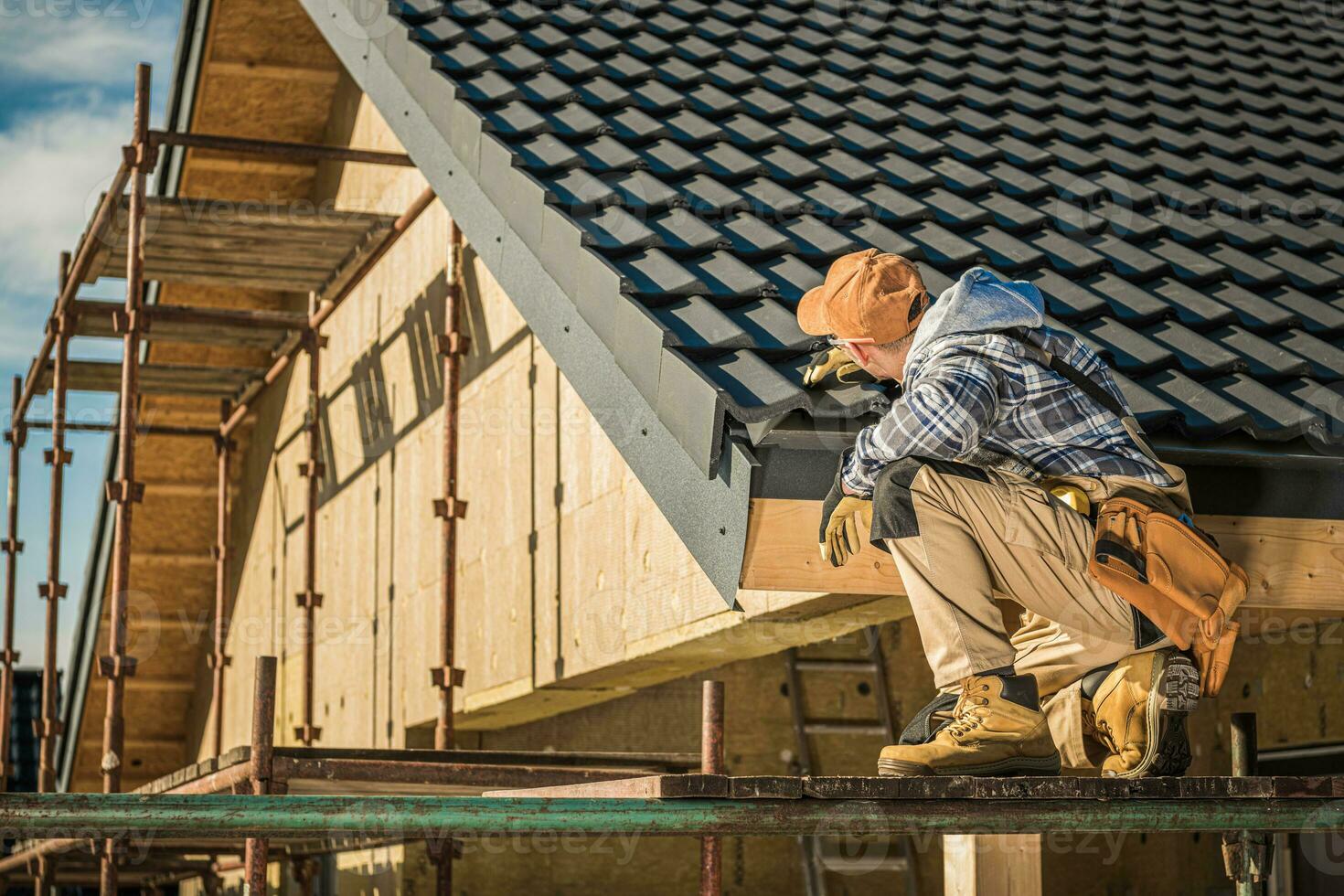 Male Roof Contractor Reviews Project Progress. photo