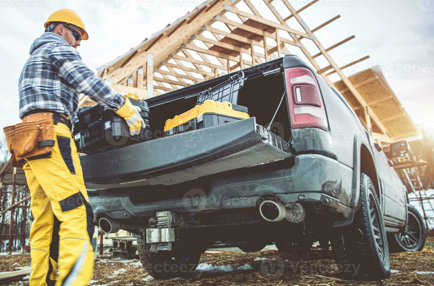 Construction Worker Taking Tools Boxes From His Pickup Truck photo
