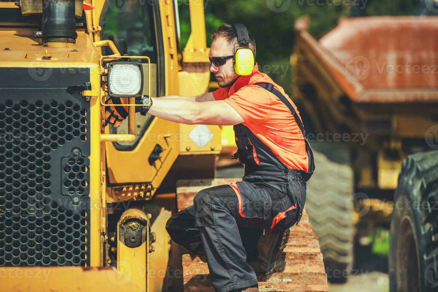 Professional Heavy Duty Machine Mechanic Performing Bulldozer Check photo