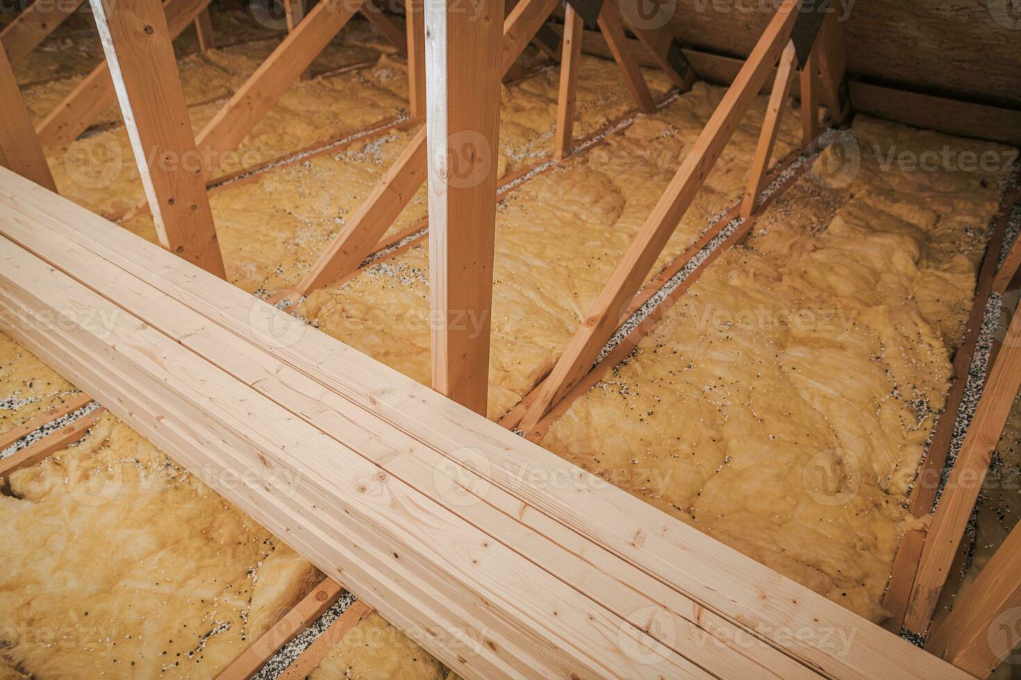 Yellow Insulation Spread On Floor In Loft. photo