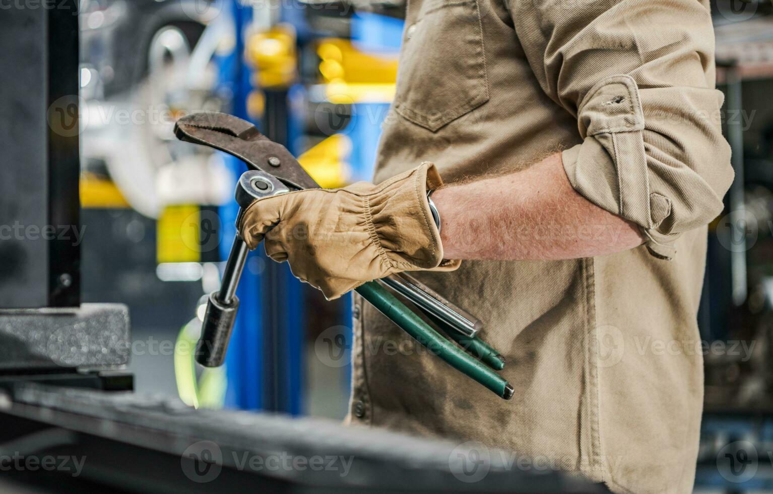 Automotive Industry Worker with Car Repairing Tools in His Hands photo