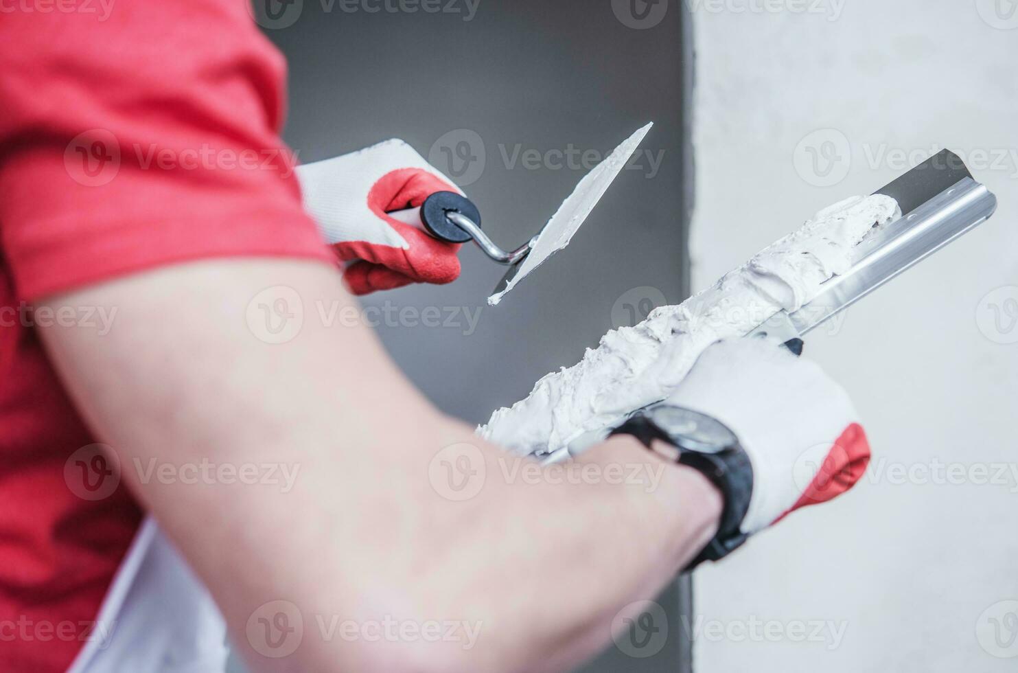 Construction Worker Applying Drywall Compound On Taping Knife. photo