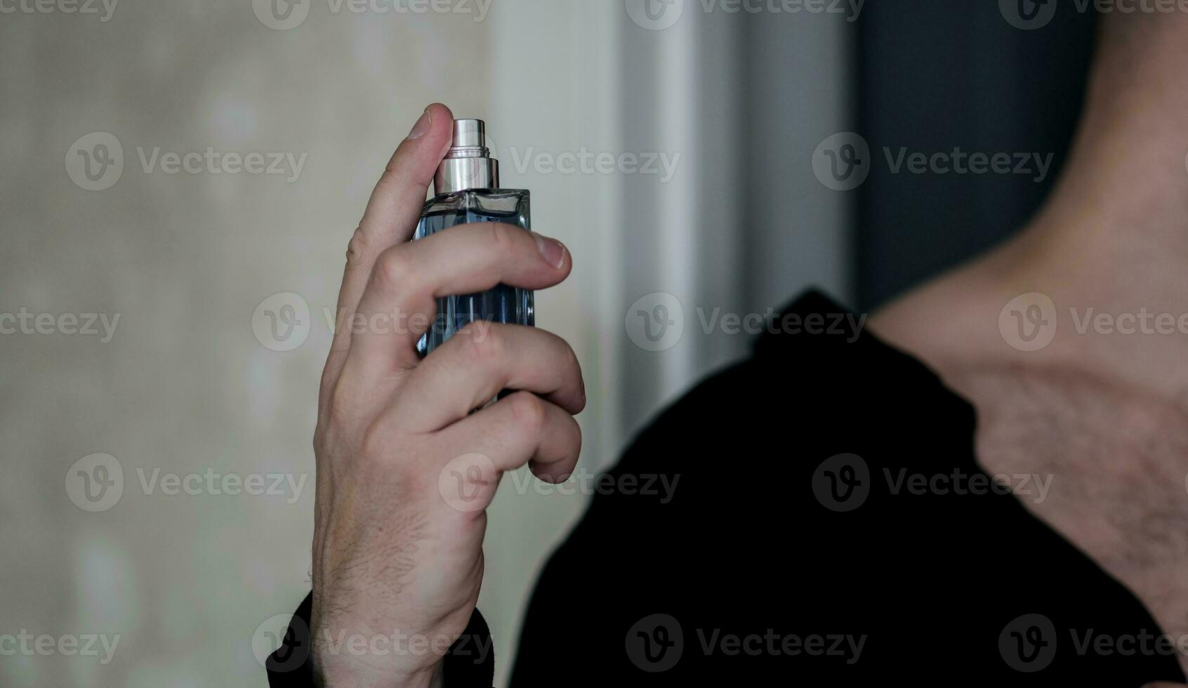 man using perfume. photo