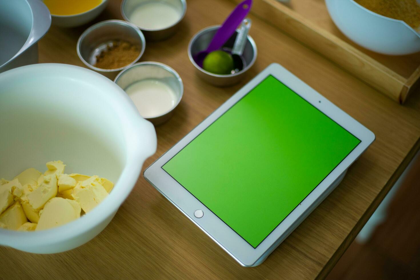 A cooking class is about to start as there are many items already prepared for it including an tablet photo