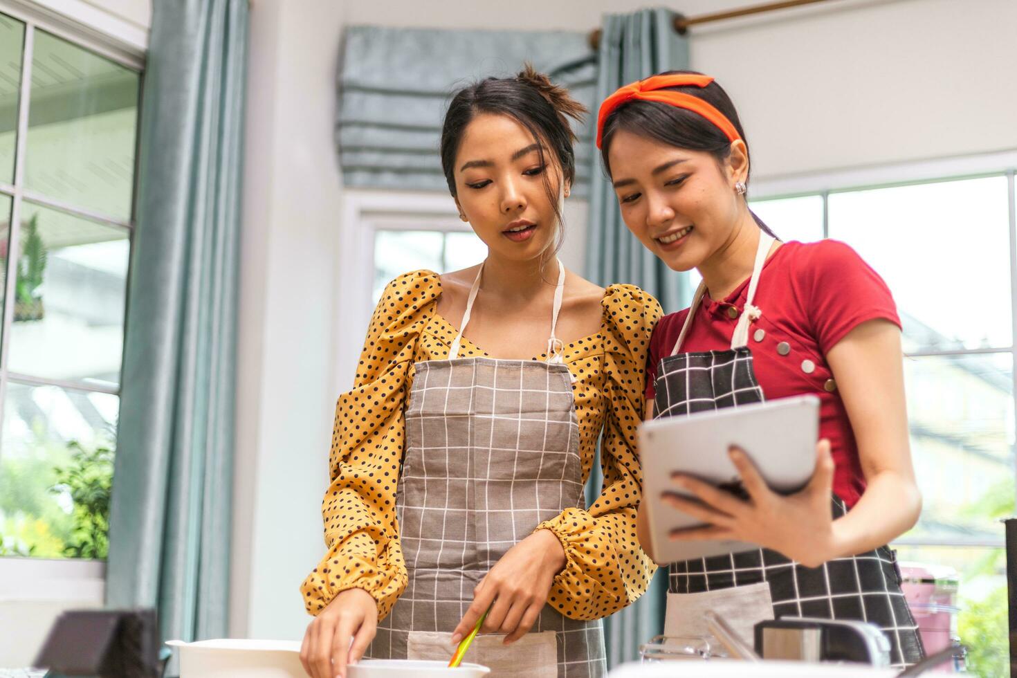 Two women are discussing and preparing an online cooking class. photo