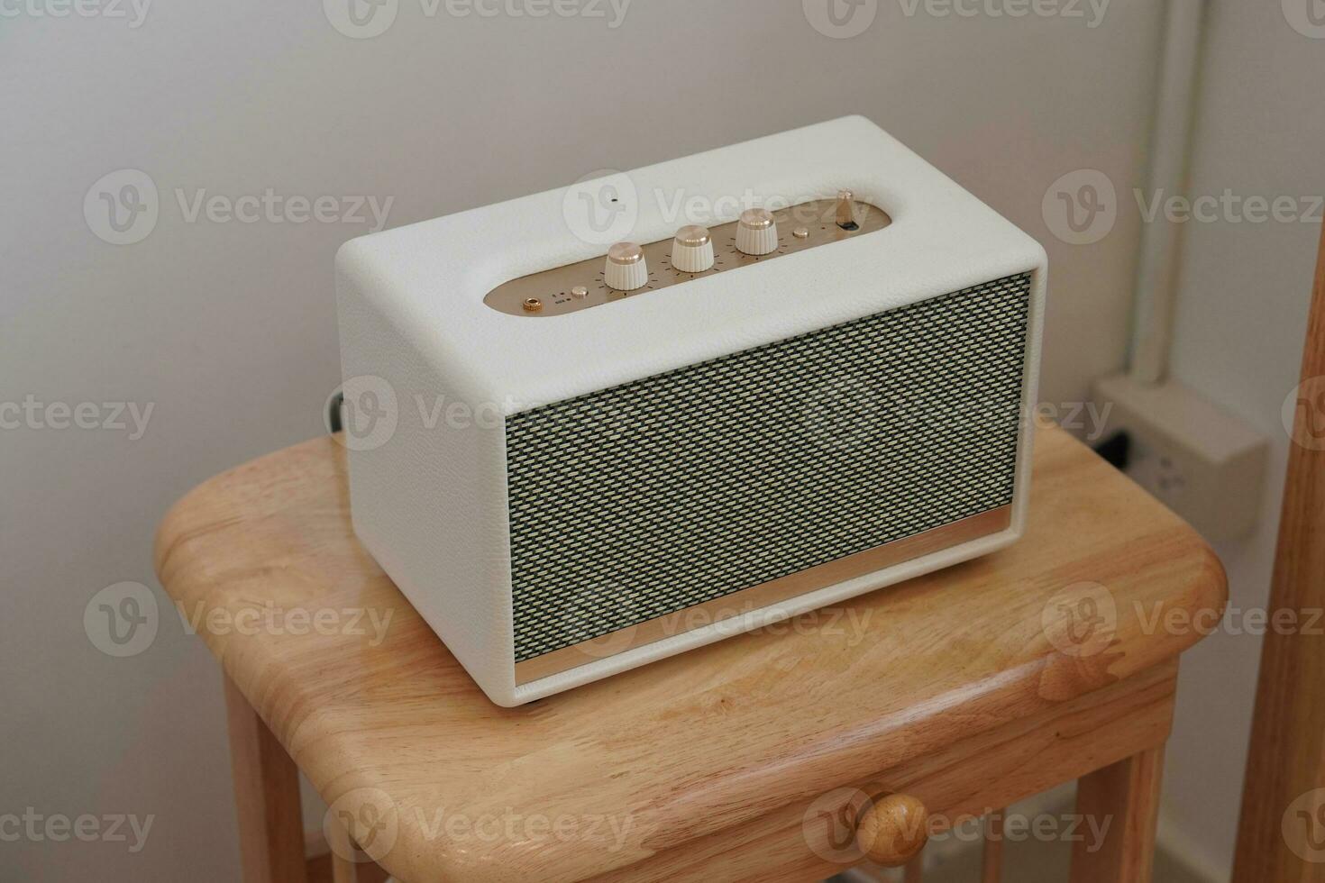 Closeup white and gold loudspeaker on wooden chair, technology, object,copy space photo