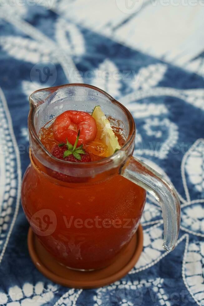 top view lemon tea in a glass jug placed on white and blue fabric background, fruit, drink, health, banner, template, copy space photo