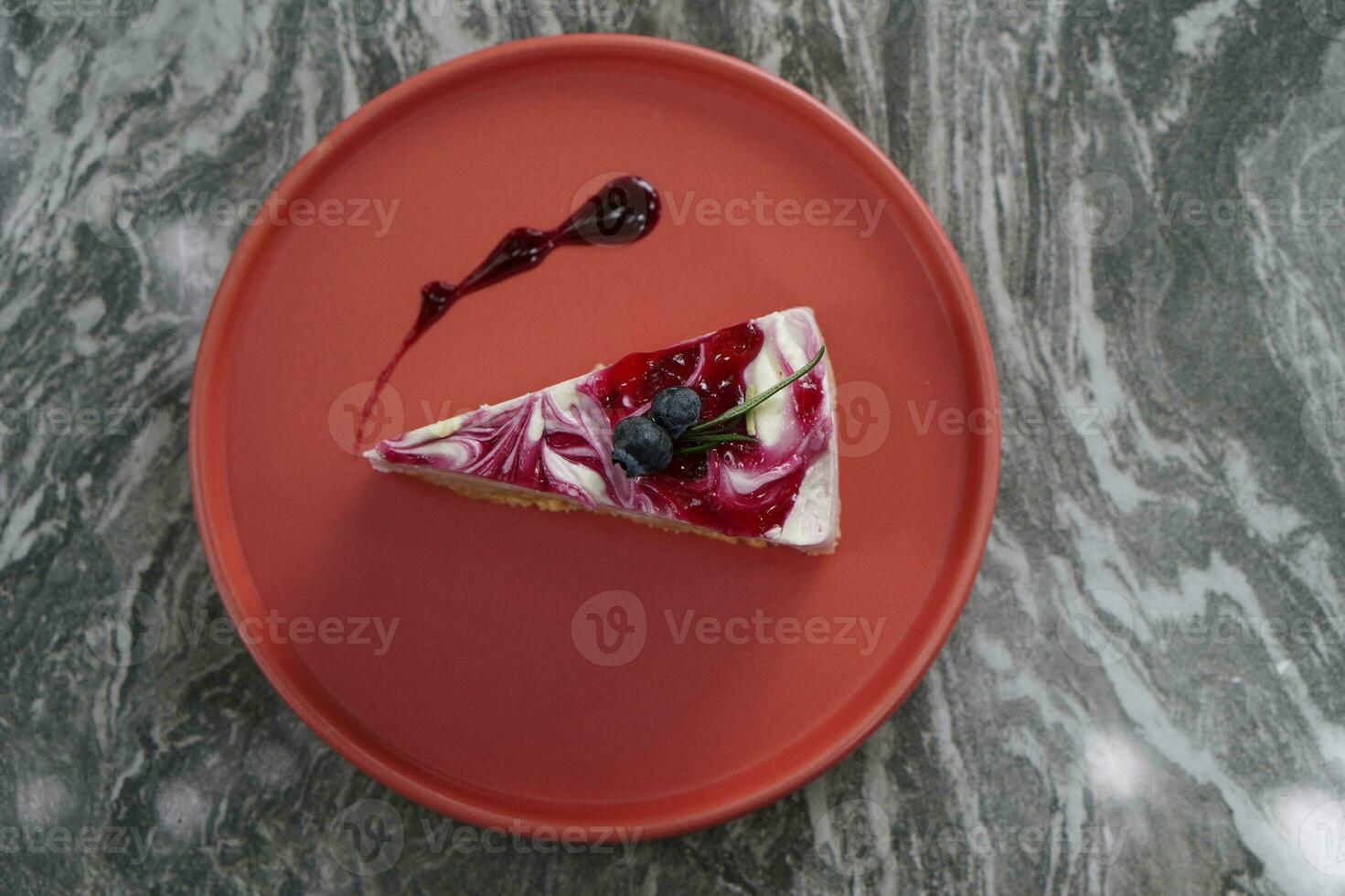 top view fruit on blueberry cheese cake on red plate on gray marble floor background, food, copy space photo