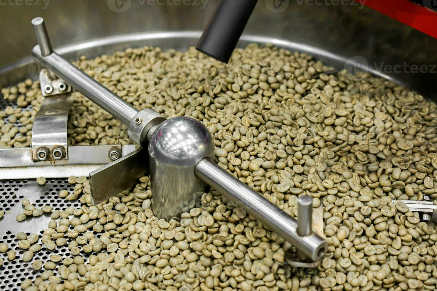 Raw coffee beans in the roast spinning cooler professional machine. photo