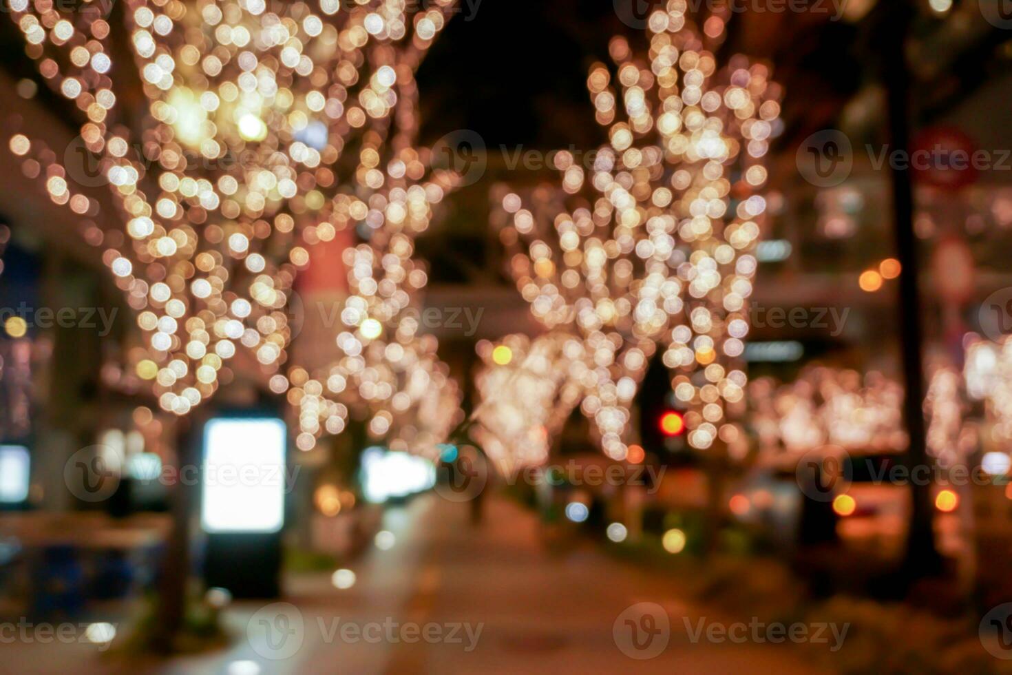 Closeup blurred and bokeh of pink LED refection lighting decorate on trees in Valentines day with city night life in Osaka, Japan. photo