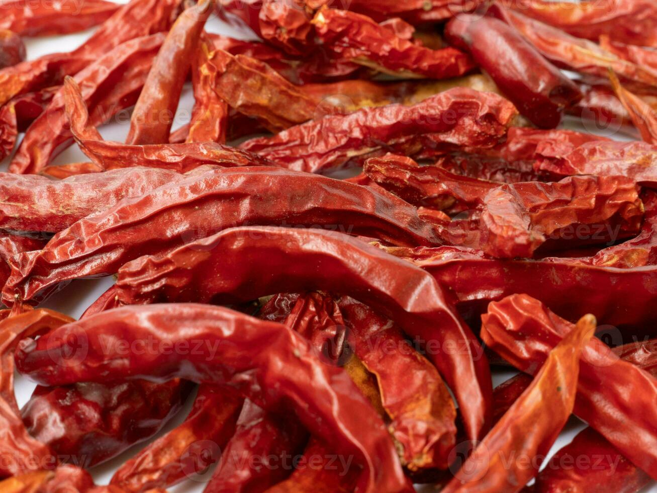 Several dried red peppers piled together photo