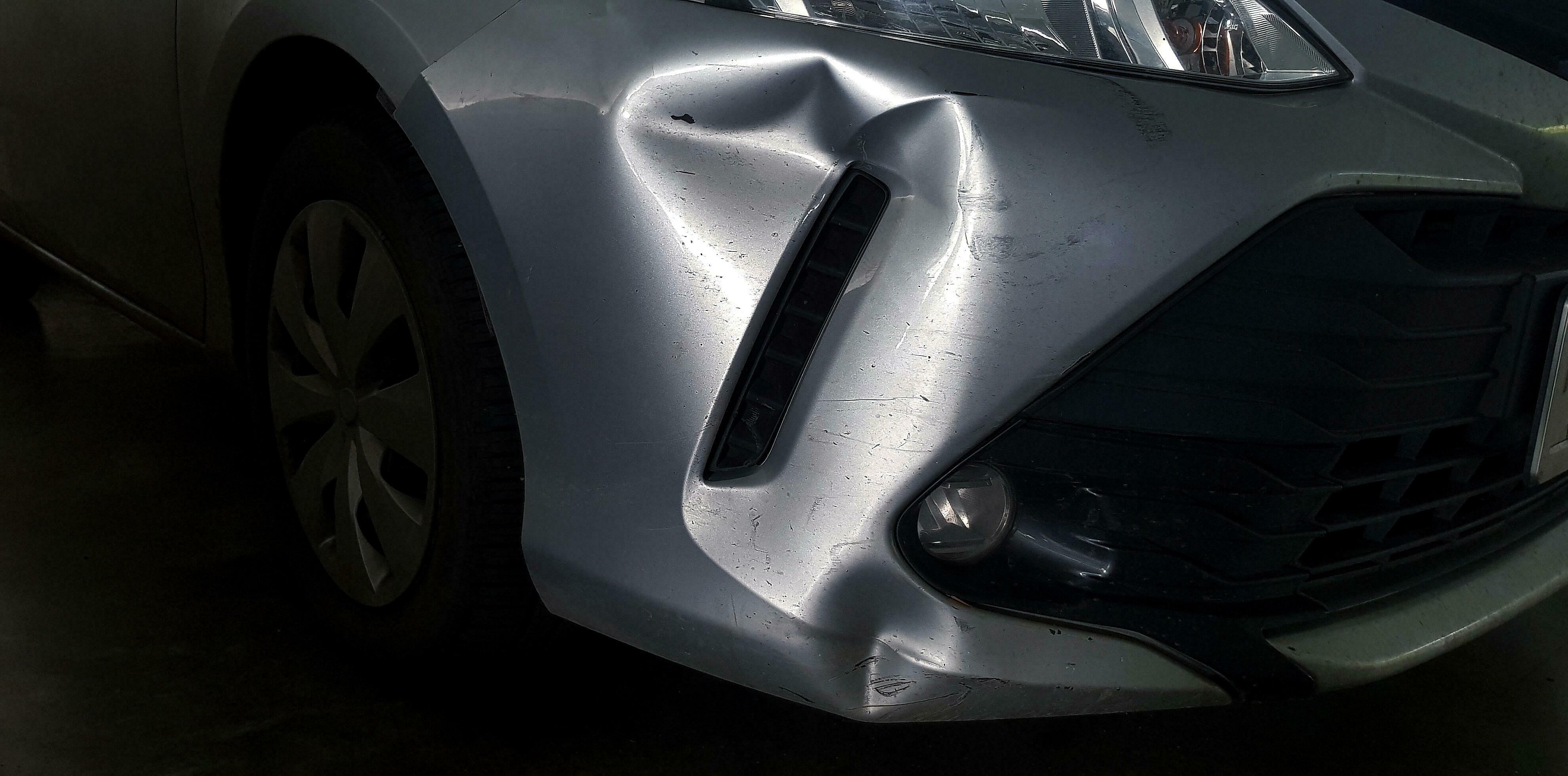 Scratches or dents on gray, grey or bronze car after accident. Damaged