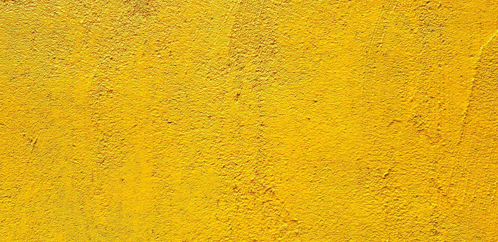 Yellow painted Rough or grunge concrete or cement wall for background - Retro wallpaper, Colorful, Painting and Texture of surface concept photo