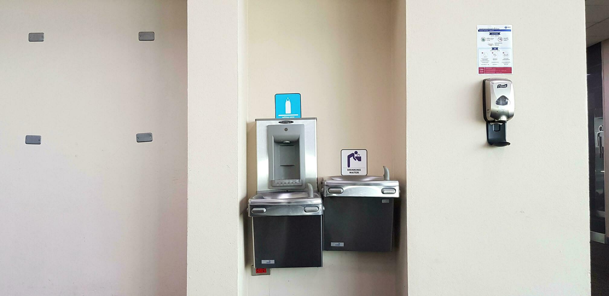 Bangkok, Thailand- May 28, 2023 Automatic drinking water and hand washers installed on wall in airport to provide services for passengers at Donmuang airport. Machine, Device Technology and Cleaning photo
