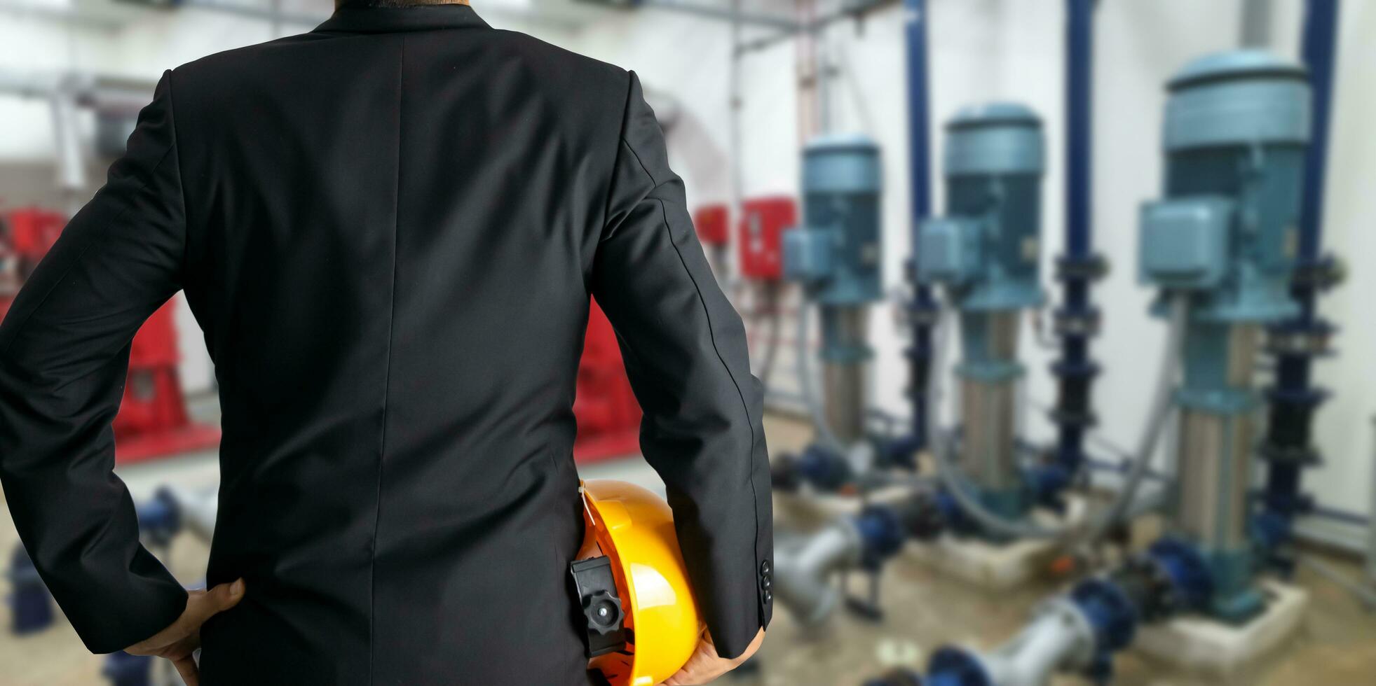 Engineering holding helmet in concept engine room Water pump system in the building photo