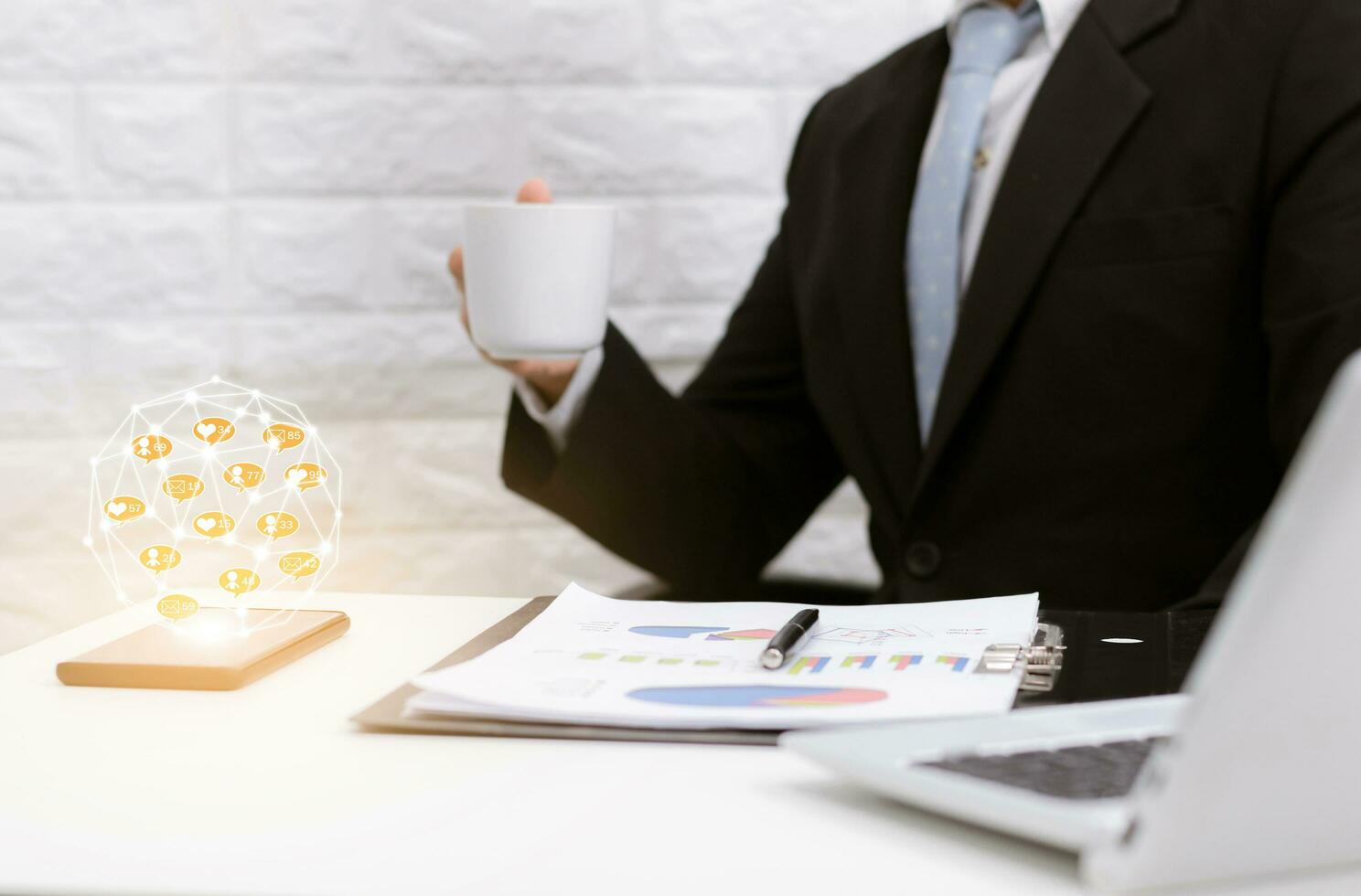 Businessman online community coffee break relax on laptop at his desk. photo